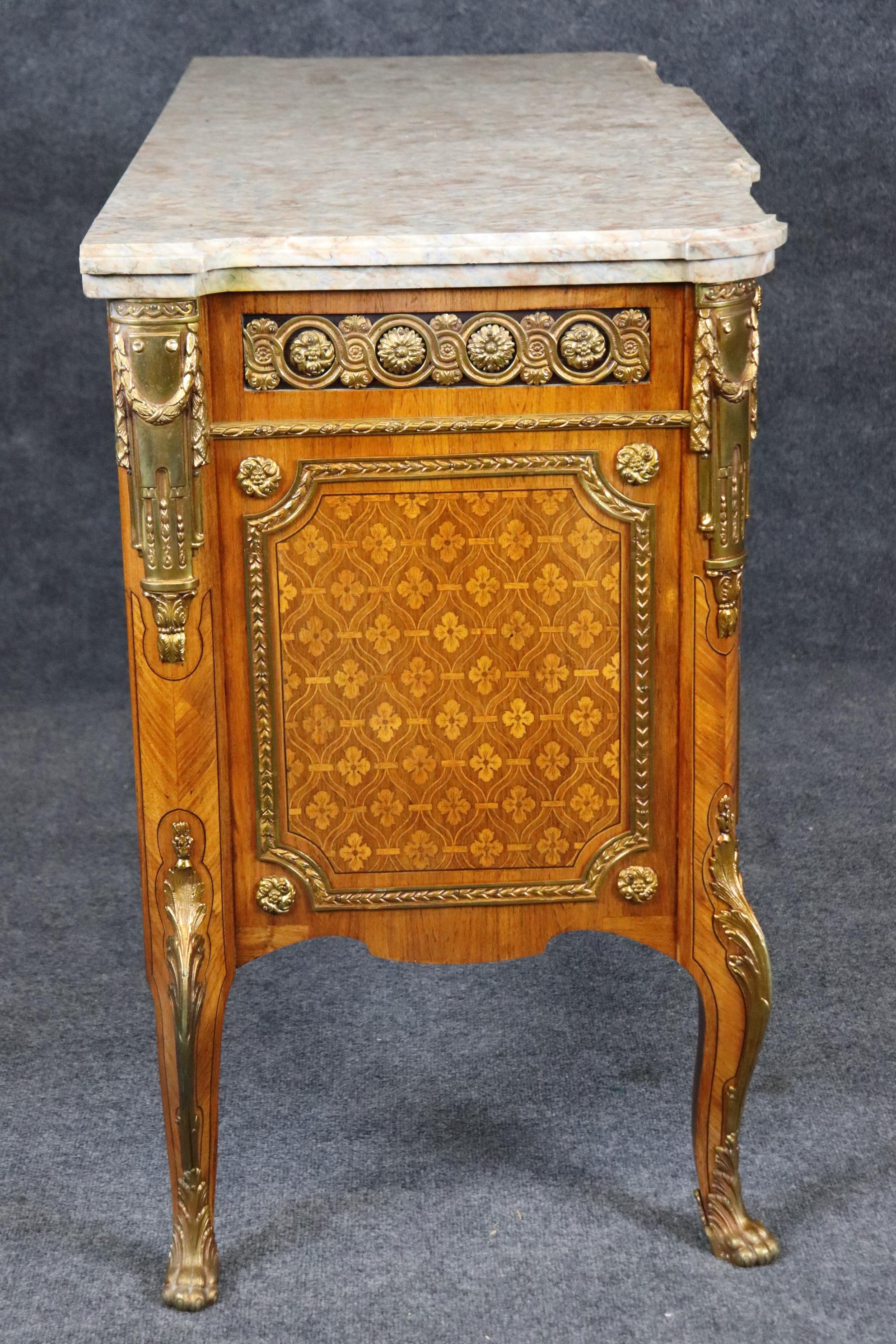 This is a superbly crafted French-made commode. The commode is in good condition with minor signs of age and use. The marble top is double the thickness of most marble tops and is in good condition. The case is satinwood inlaid and walnut with