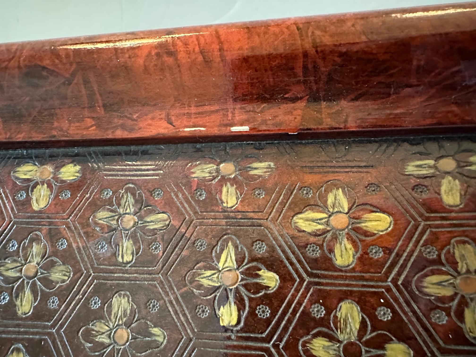 Stunning large square carved wood coffee table by John Widdicomb having an Asian flair in a marvelous shade of dark reddish brown. Carvings are detailed with gilding and are a beautiful array of flowers, unicorns and flying mythological creatures.