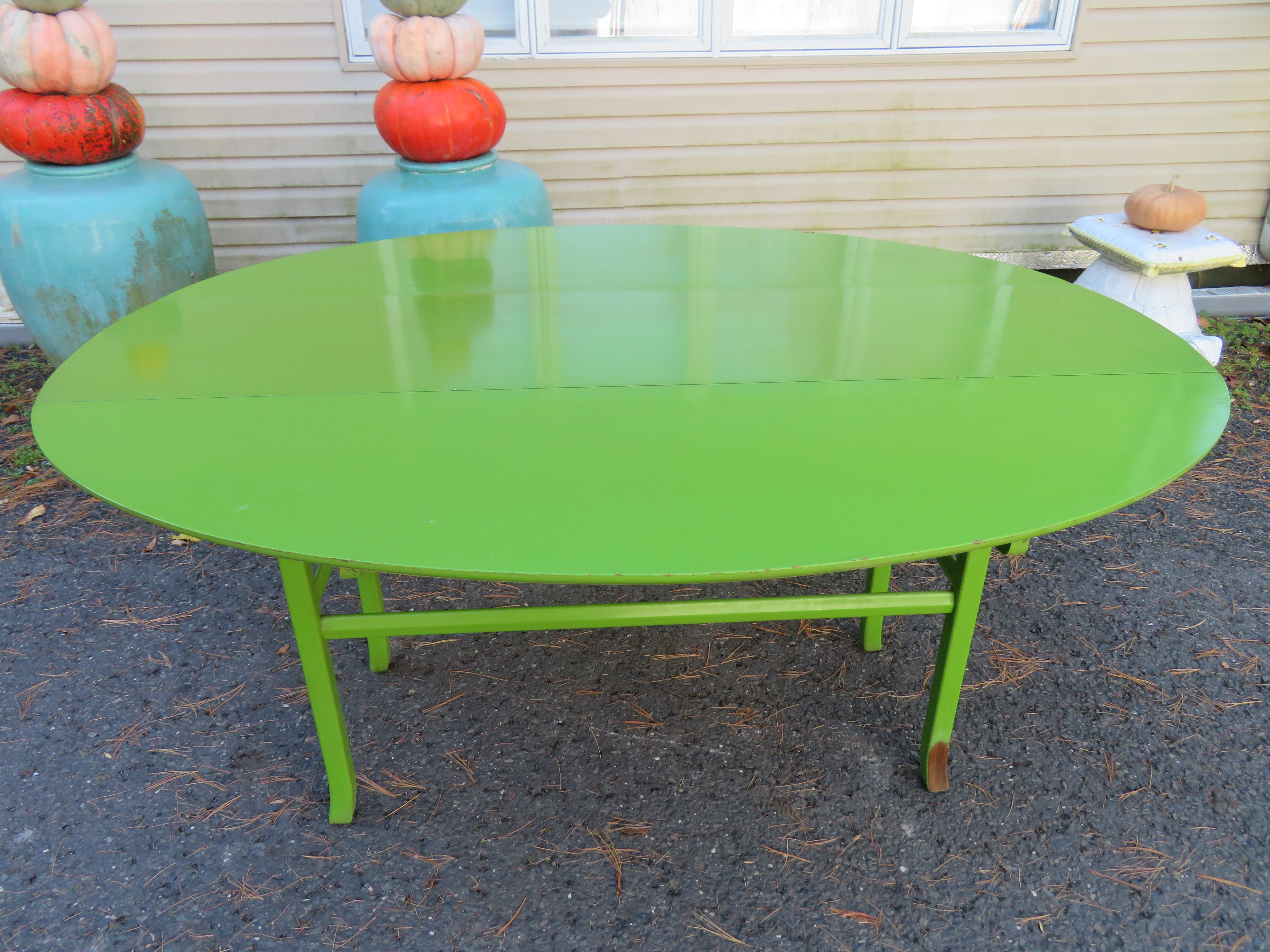 Fantastic pop-colored drop leaf console table from the mid-century. We love everything about this fun and useful table from the lime green color to the fact that this table can serve 2 functions. It can sit behind your sofa as a console or sofa