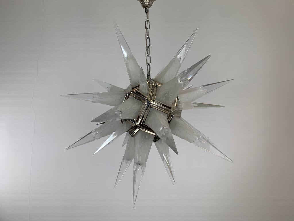 Illuminate your home with a touch of celestial beauty with this exquisite pair of rock crystal star chandeliers. These stunning fixtures will add a touch of elegance and sophistication to any room, creating a magical ambiance that will captivate all