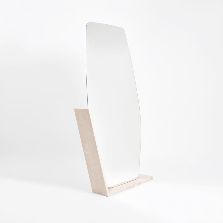 Fantastic mirror M by Project 213A
Dimensions: D 20 x W 95 x H 196 cm
Materials: Mirror, travertine stone, wood.

The Mirror has an organic shape cut in mirror glass backed with wood to be secure and stable. The foot is made entirely from travertine