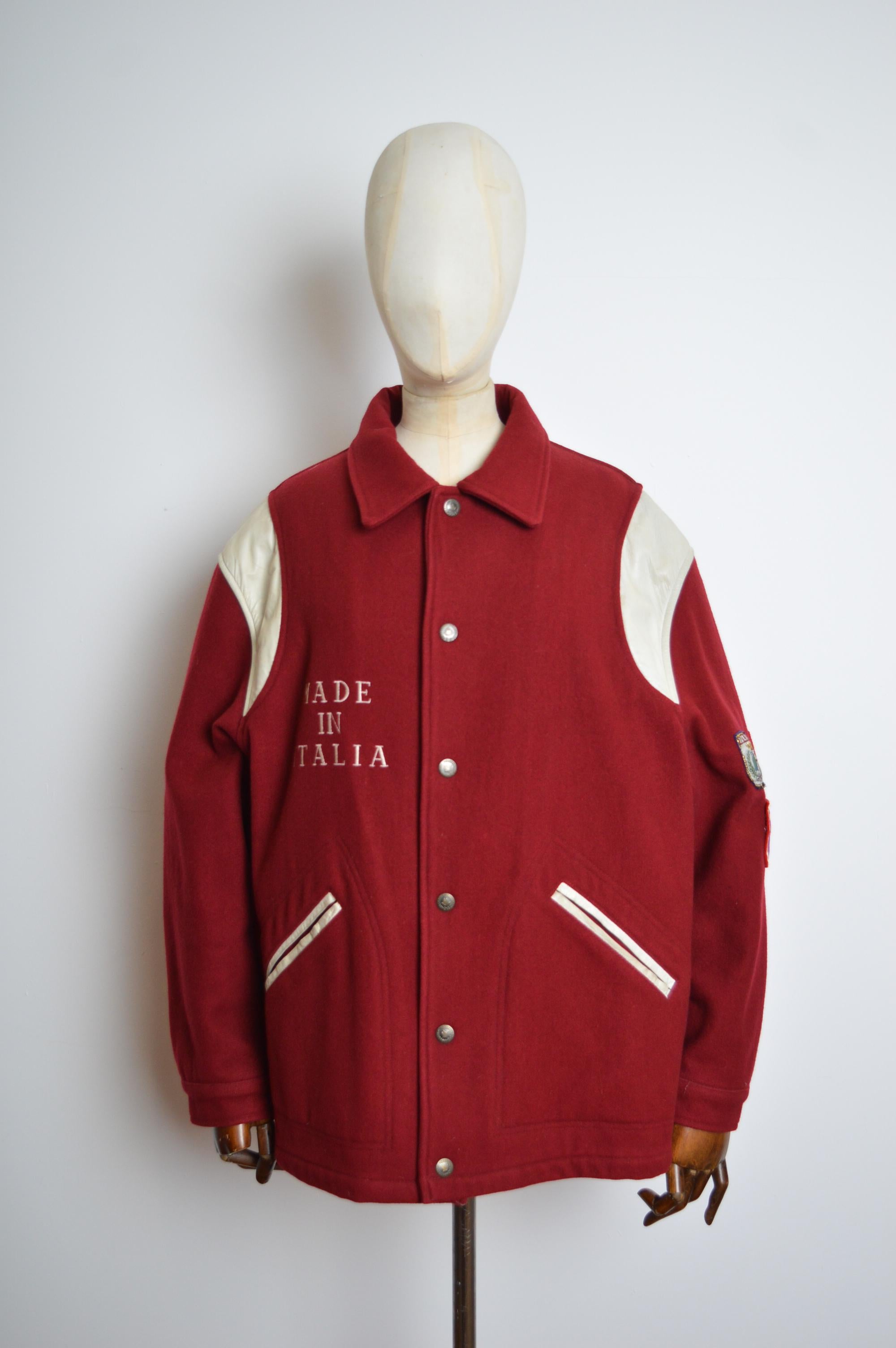 Franco Moschino early 1990's fun, Maroon pure wool Varsity coat with intercepting white leather panelled shoulders and ornate patch decorations on the sleeve. 
MADE IN ITALY.
Long sleeves - hip pockets - quilted lining - press stud closure.
Pit to
