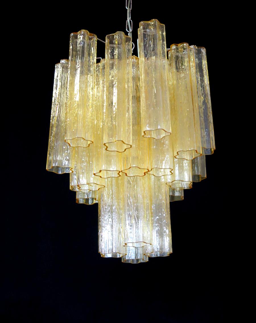 Italian vintage chandelier in Murano glass and nickel-plated metal structure. The armour polished nickel supports 30 large clear amber or gold glass tubes.
Period: 1970s
Dimensions: 47.25 inches (120 cm) height with chain; 24.80 inches (63 cm)