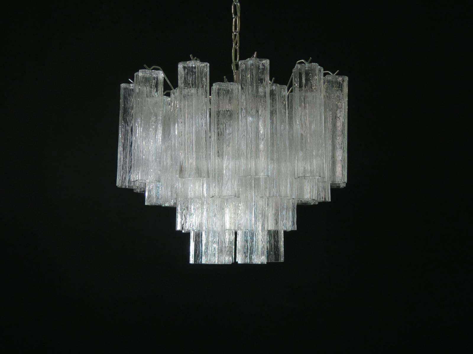 
Italian vintage chandelier in Murano glass and nickel-plated metal structure. The armor polished nickel supports 36 large clear glass tubes in a star shape.
Period:	late XX century
Dimensions: 45,30 inches (115 cm) height with chain; 19,70 inches