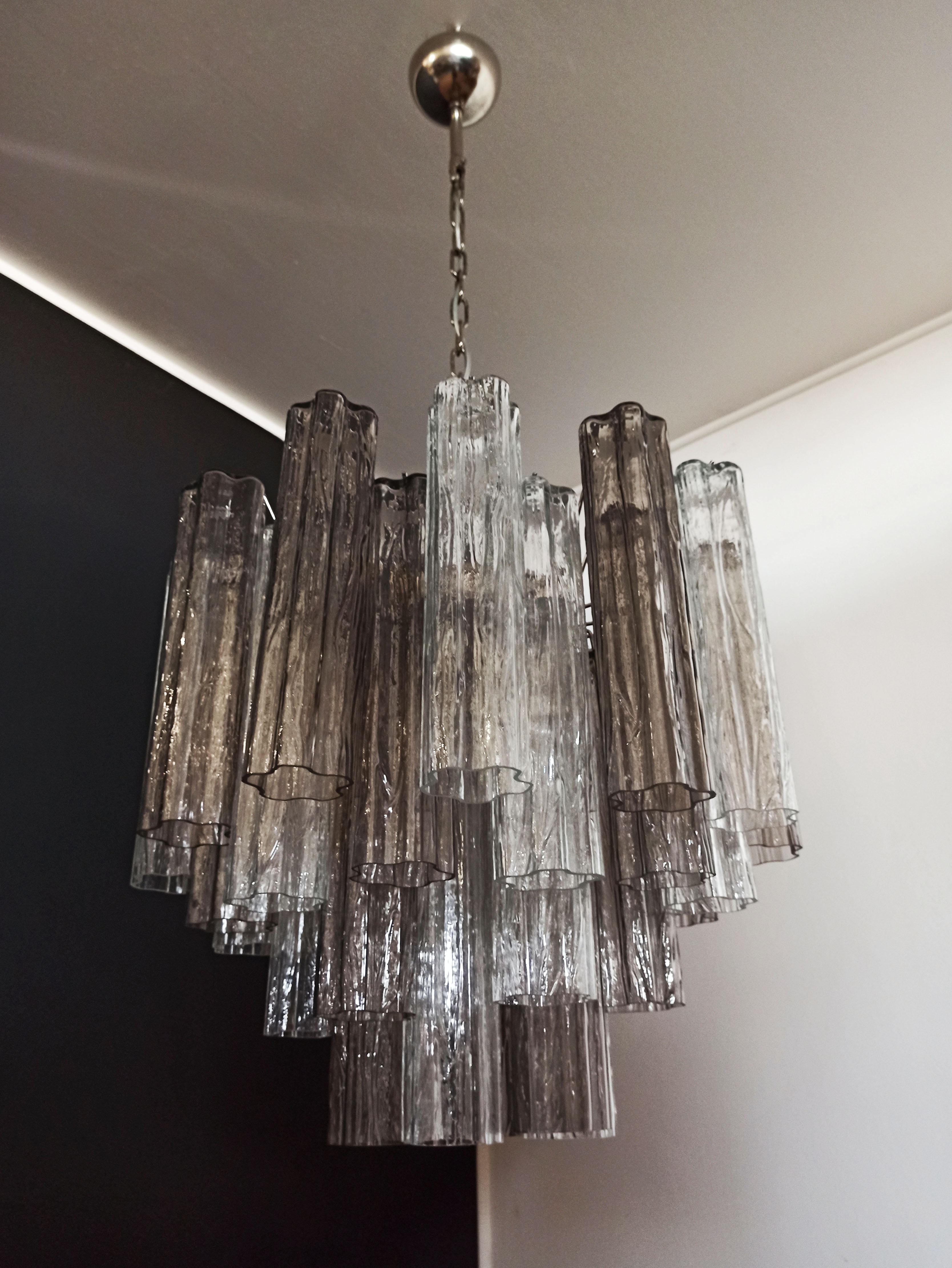 Italian vintage chandelier in Murano glass and nickel-plated metal structure. The armor polished nickel supports 36 large smoked  and clear glass tubes in a star shape. (18 smoked glasses + 18 trasparent glasses)
Period:	late XX century
Dimensions: 