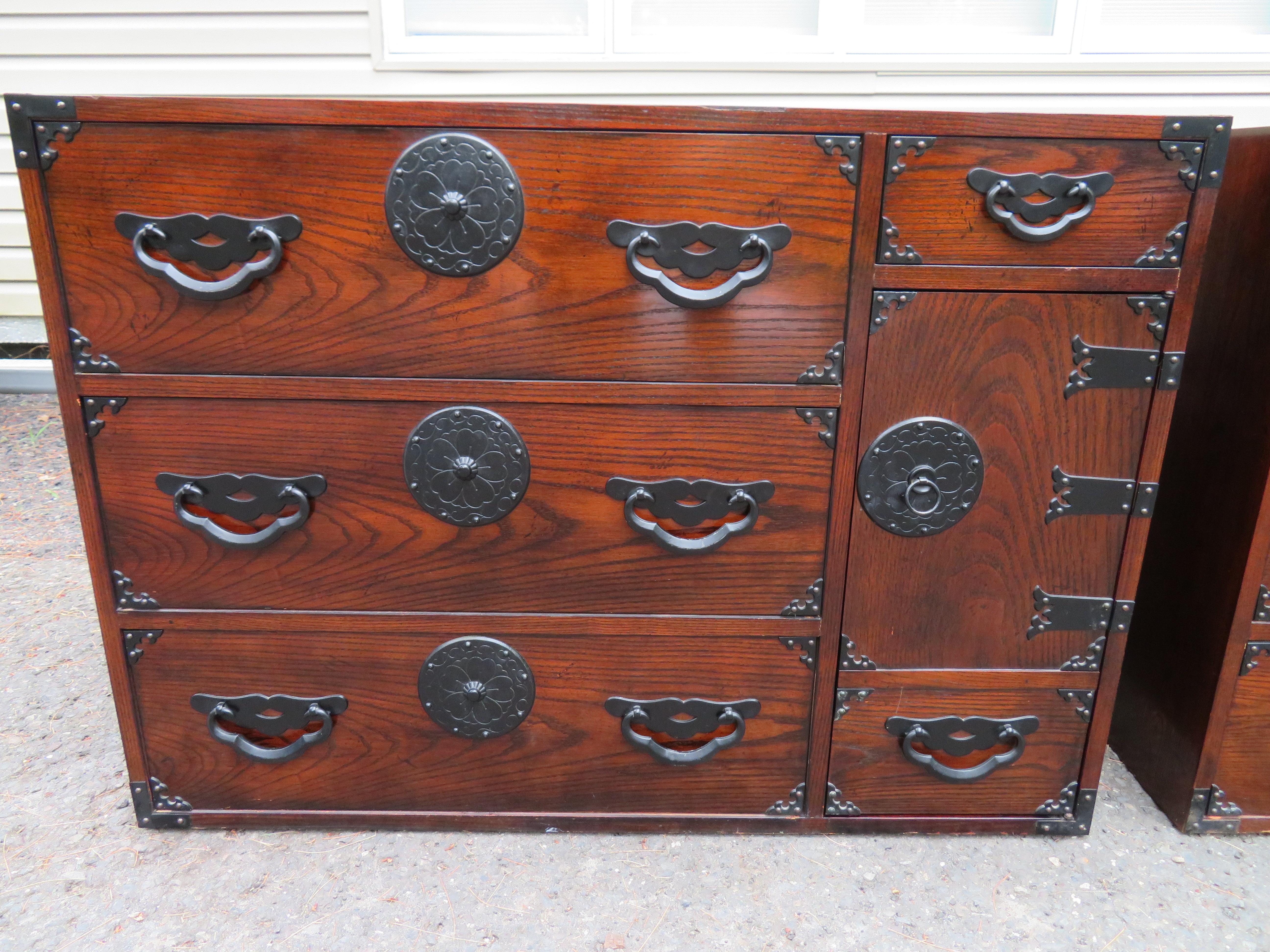 Amazingly beautiful pair of Japanese Tansu bachelors chests by Baker. Dark stained oak with fantastic Japanese-inspired hardware. They have a time-worn patina with splendid charm. I love the vintage look of these- give your interior real Mid-century