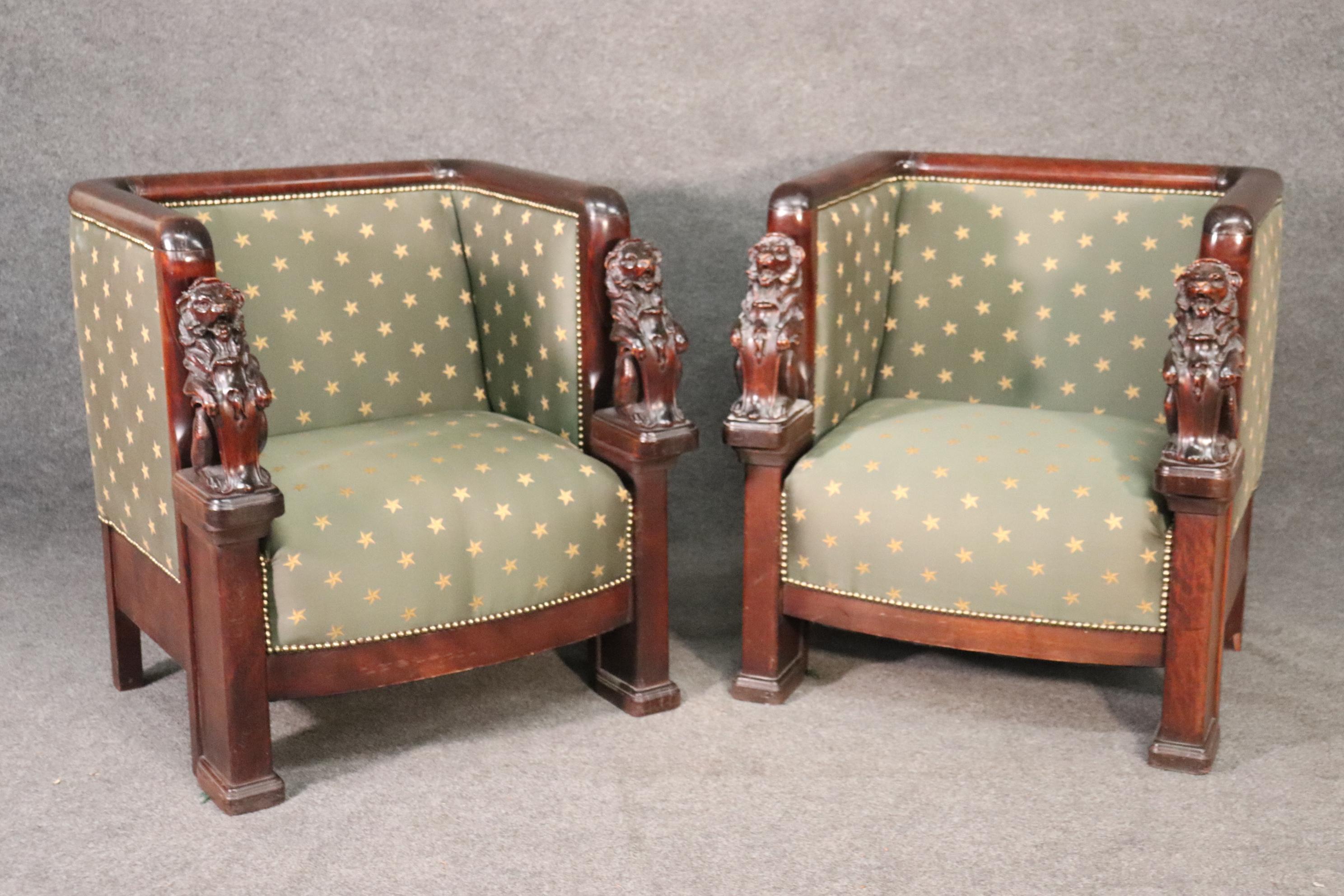 This is a stunning pair of French Empire throne chairs. They have incredible upholstery which is most likely silk and the carved full-standing lions are beautifully carved. There is a matching sofa exactly like these listed seperately. These chairs