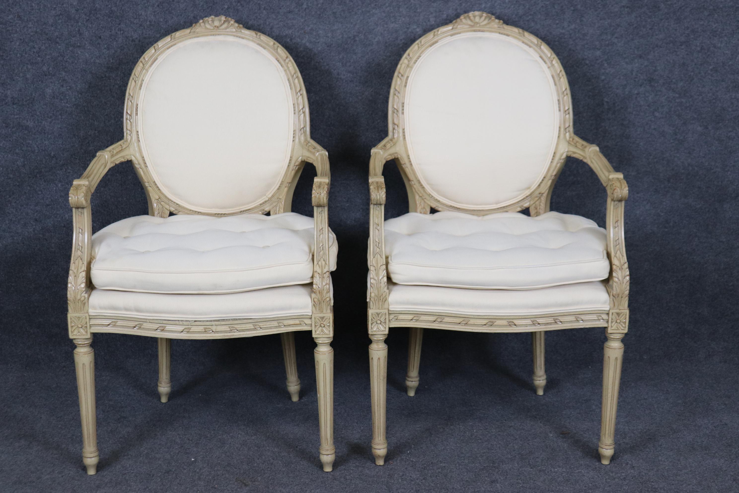 This is a gorgeous pair of hand-carved frames made in Europe, either France or Italy. They are finished in a hand-rubbed intentionally destressed creme painted finish. The corduroy style velour is in relatively good condition and does have a visible