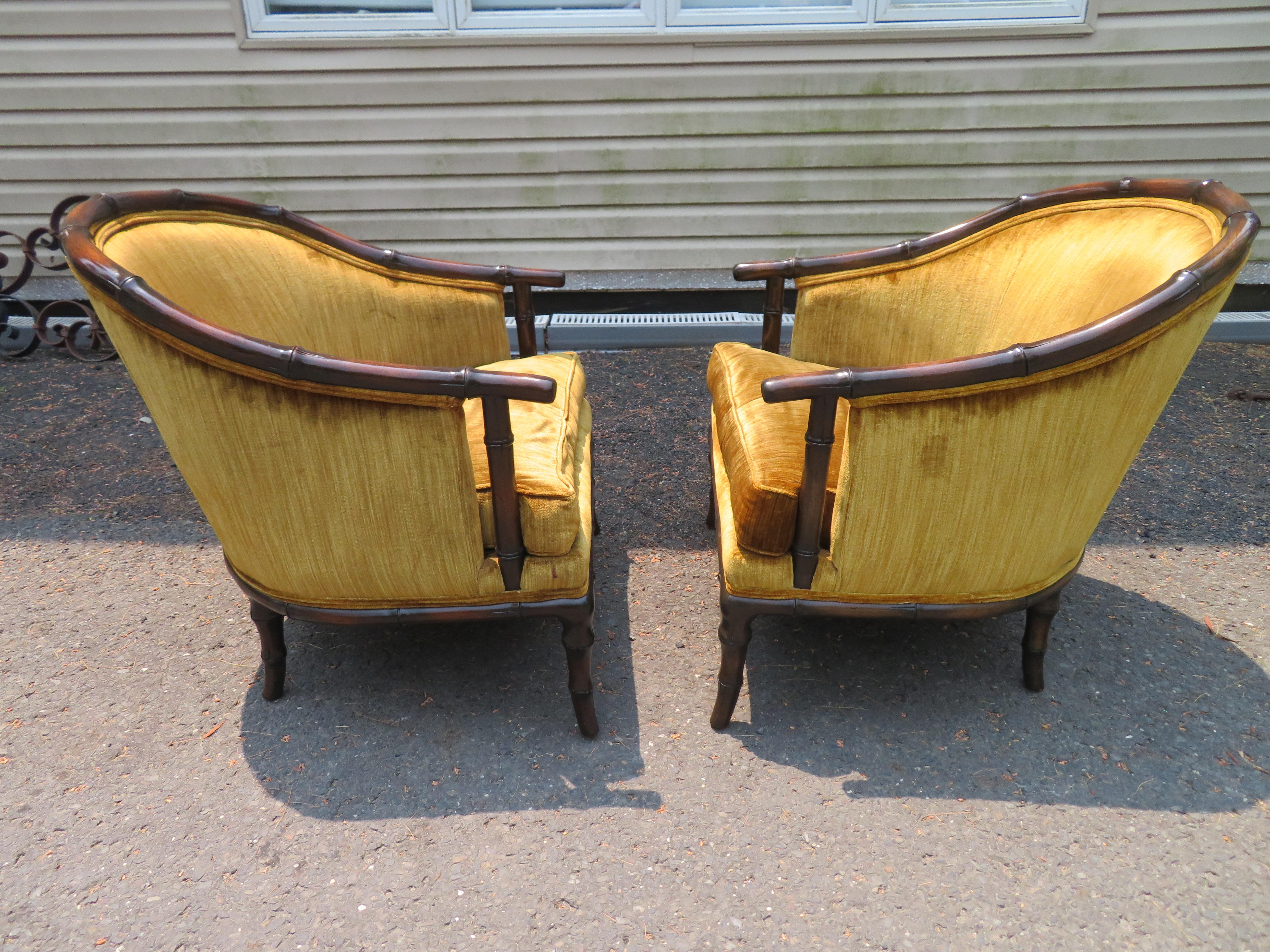 Vintage pair of Hollywood Regency faux bamboo barrel back arm club chairs. These charming chairs retain their original golden avocado velvet still in presentable condition. They Measure 29