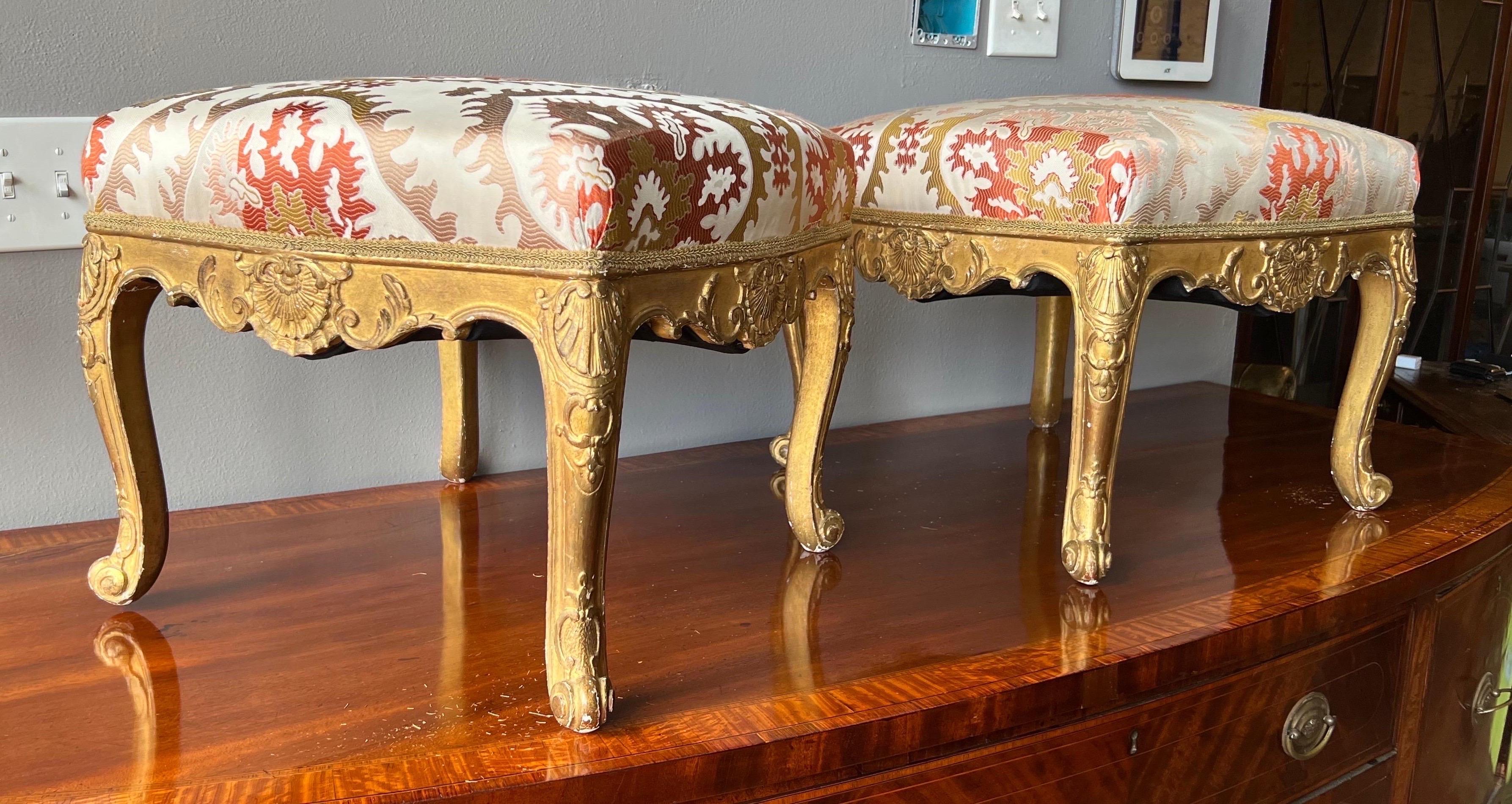 Fantastic pair of 18th-19th century French gold gilt wood stools in attractive upholstery from an estate in the residence side of the Carlyle in Manhattan.