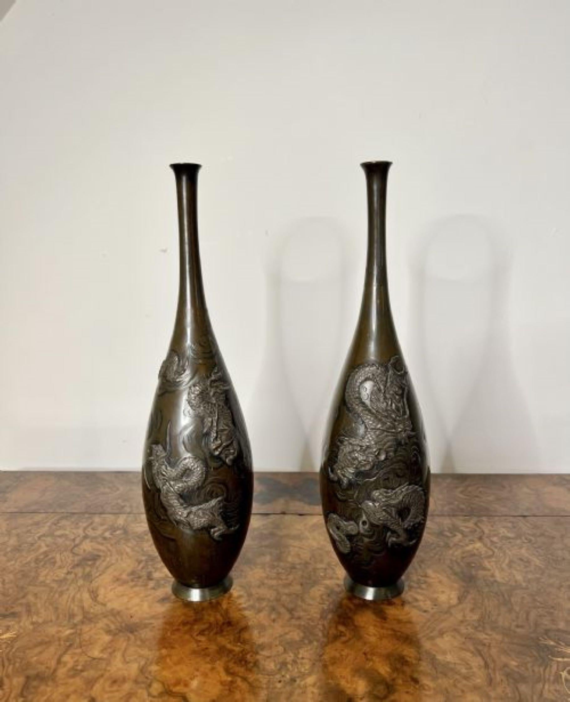 Fantastic pair of antique Japanese bronze vases, having a wonderful shaped body, Meiji period bronze Japanese vases decorated in relief with dragons.
