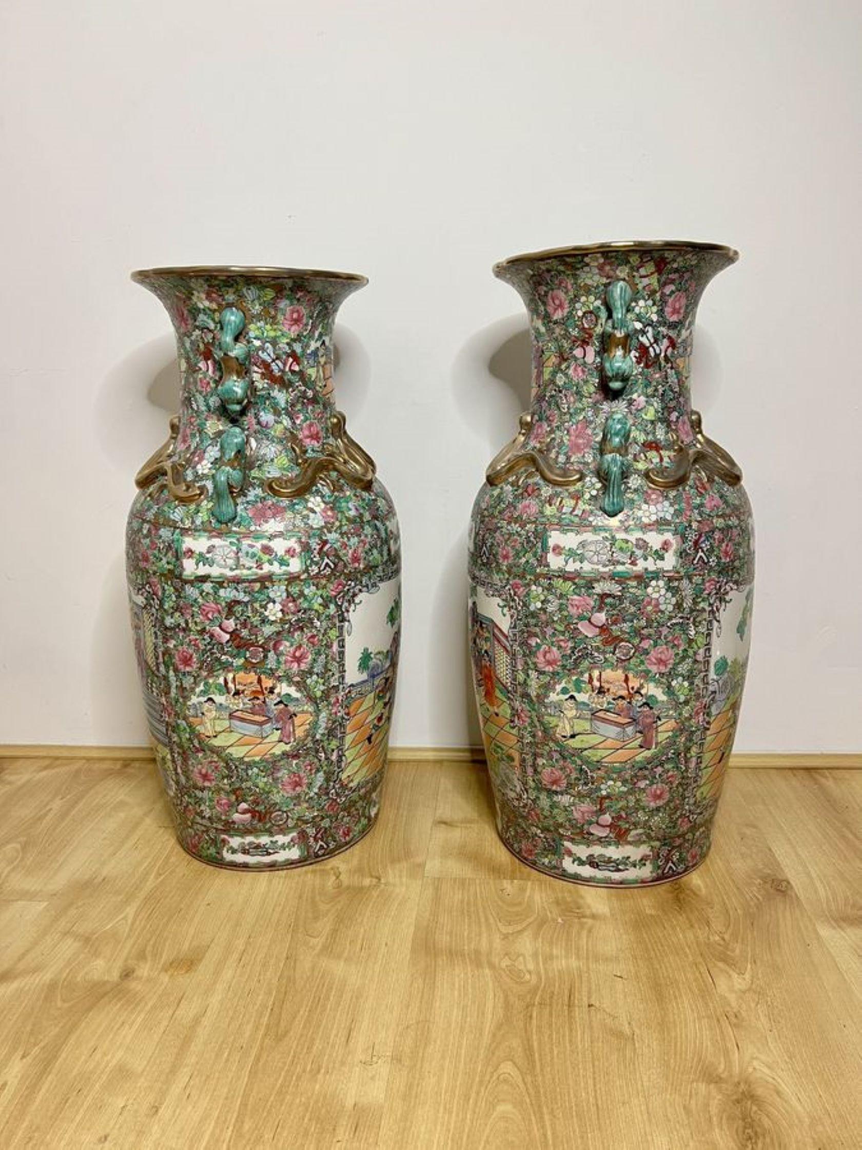 Fantastic pair of antique large Chinese floor standing vases having a pair of large antique Chinese floor standing vases, fantastic decoration in canton style in wonderful green, pink, blue, red and white colours, having twin dragon handles to the