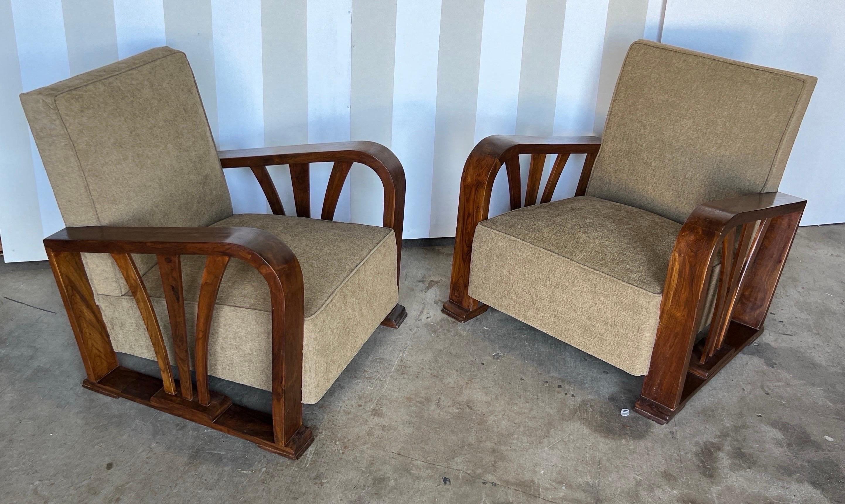 Fantastic pair of British Colonial deco period club chairs. Oversized and extremely comfortable made of teak from the East or West Indies in the 1930s. 