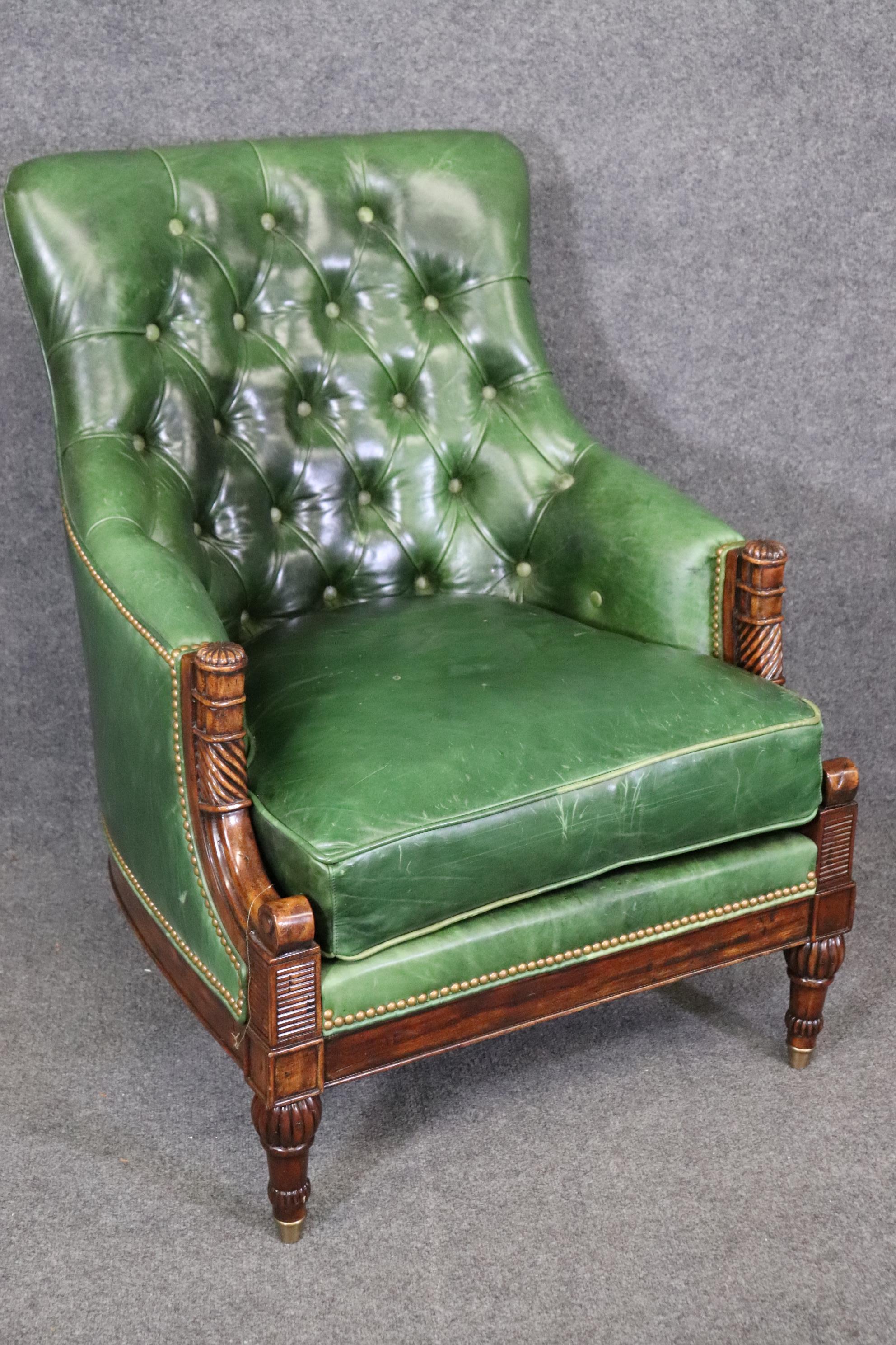 This is a spectacular pair of green leather Edwardian style Theodore Alexander mahogany club or bergere chairs. The chairs are in good original condition and will show minor signs of age and use but nothing significant. The chairs aren't that old