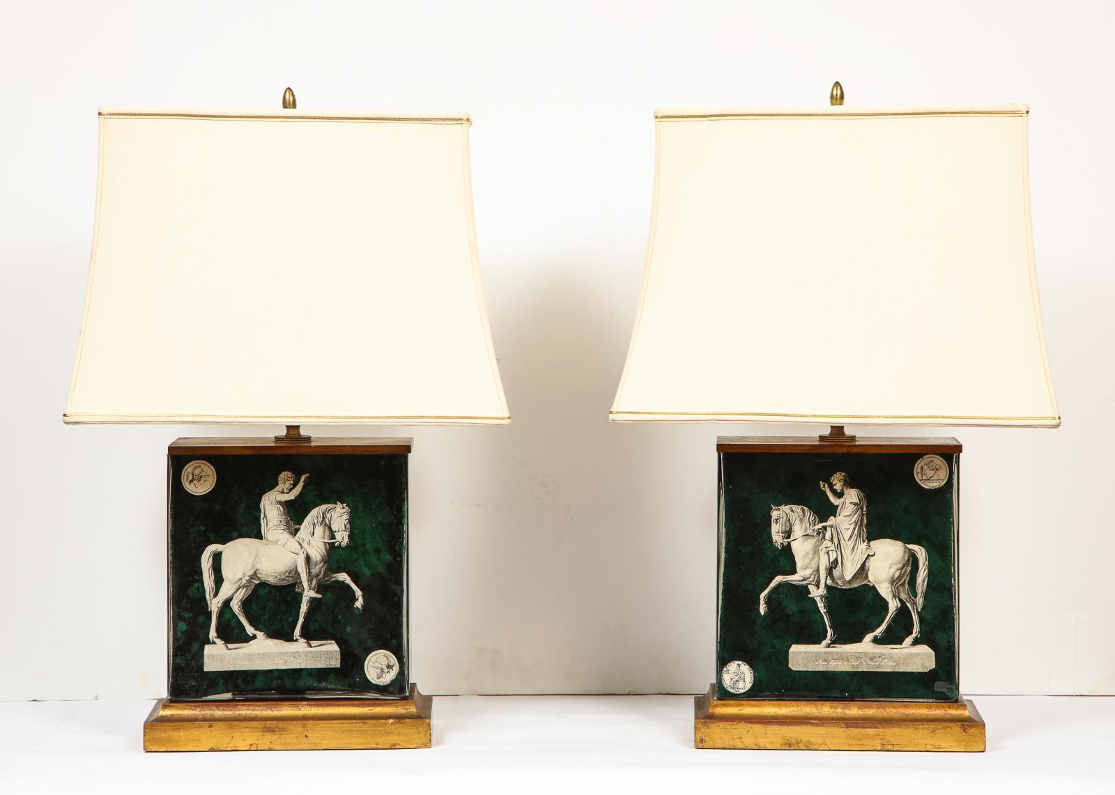 Fantastic pair of midcentury Italian green molded glass lamps, with horses, after the antique, attributed to Piero Fornasetti, circa 1950, Milan.

Mounted on giltwood.

With original shades.

Very decorative lamps, very high quality. 

Measures:
