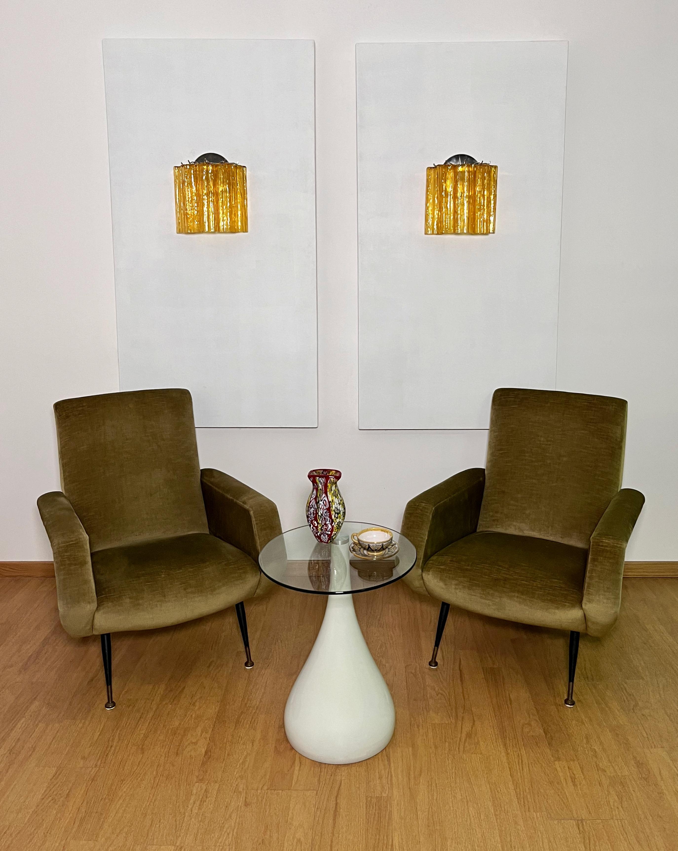 Italian vintage pair of wall sconces in Murano glass and nickel-plated metal structure. The armor polished nickel supports 5 large amber glass tubes in a star shape for each lamp.
Period:	late XX century
Dimensions: 10,50 inches height (27 cm);