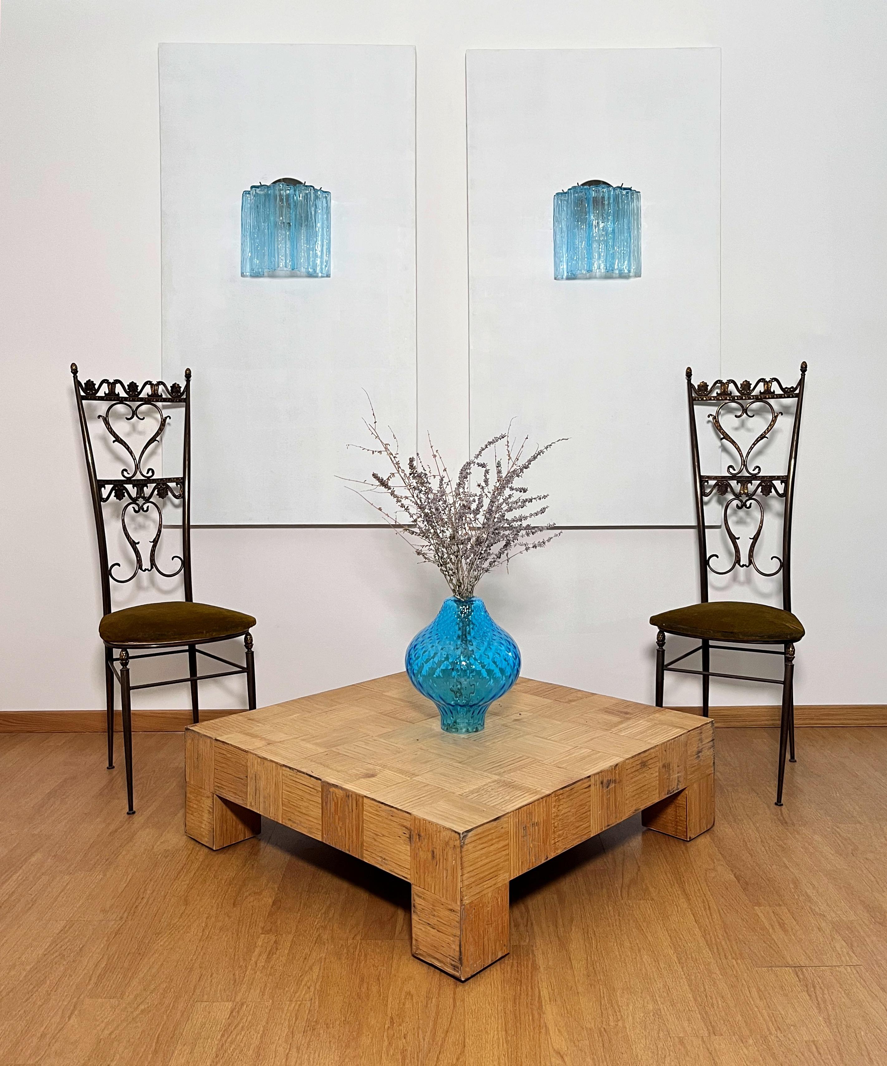 Italian vintage pair of wall sconces in Murano glass and nickel-plated metal structure. The armor polished nickel supports 5 large blue glass tubes in a star shape for each lamp.
Period:	late 20th century
Dimensions: 10.50 inches height (27 cm);