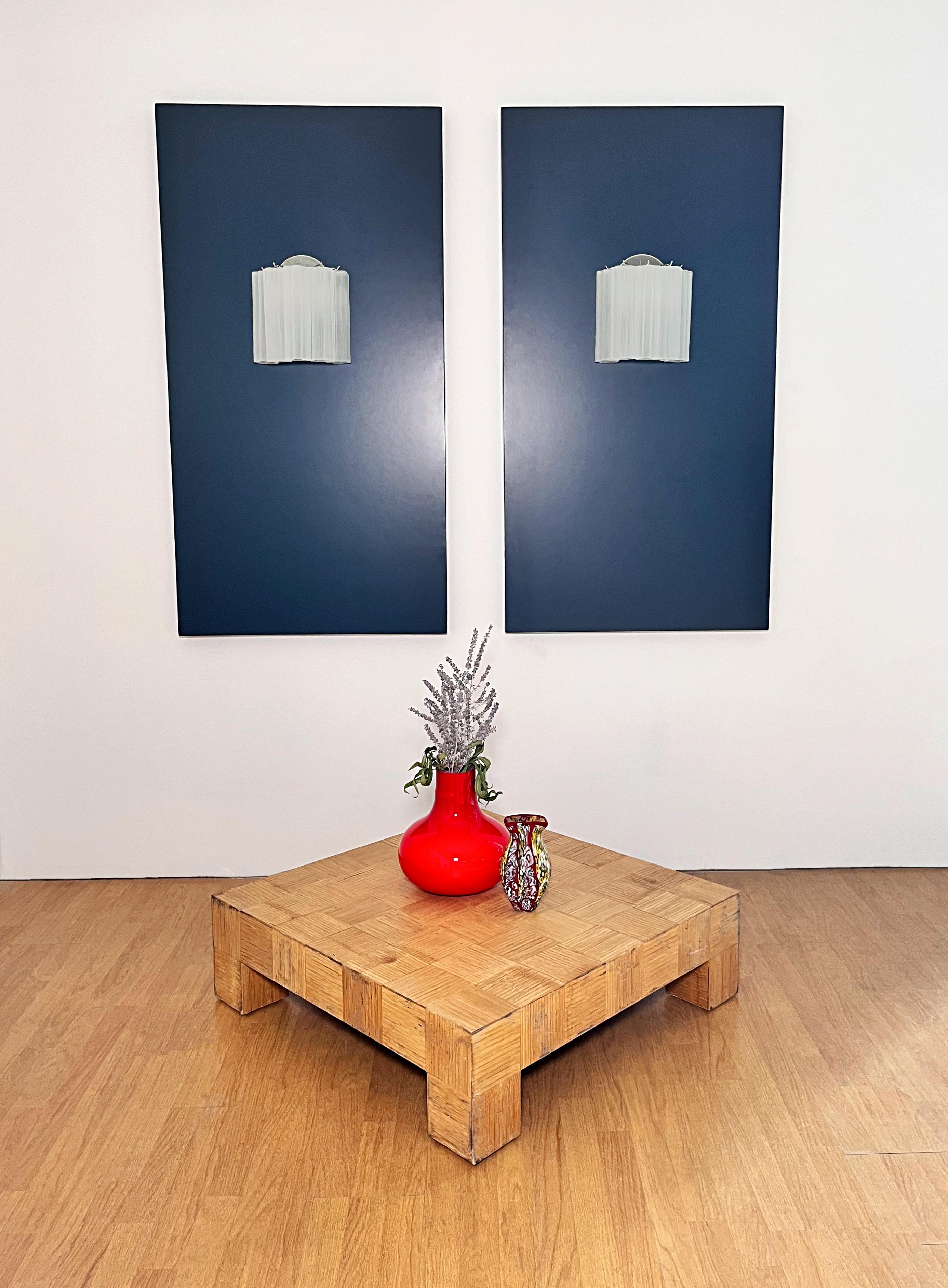 Italian vintage pair of wall sconces in Murano glass and nickel-plated metal structure. The armor polished nickel supports 5 largeetched glass tubes  in a star shape for each lamp.
Period:late XX century
Dimensions: 10,50 inches height (27 cm);