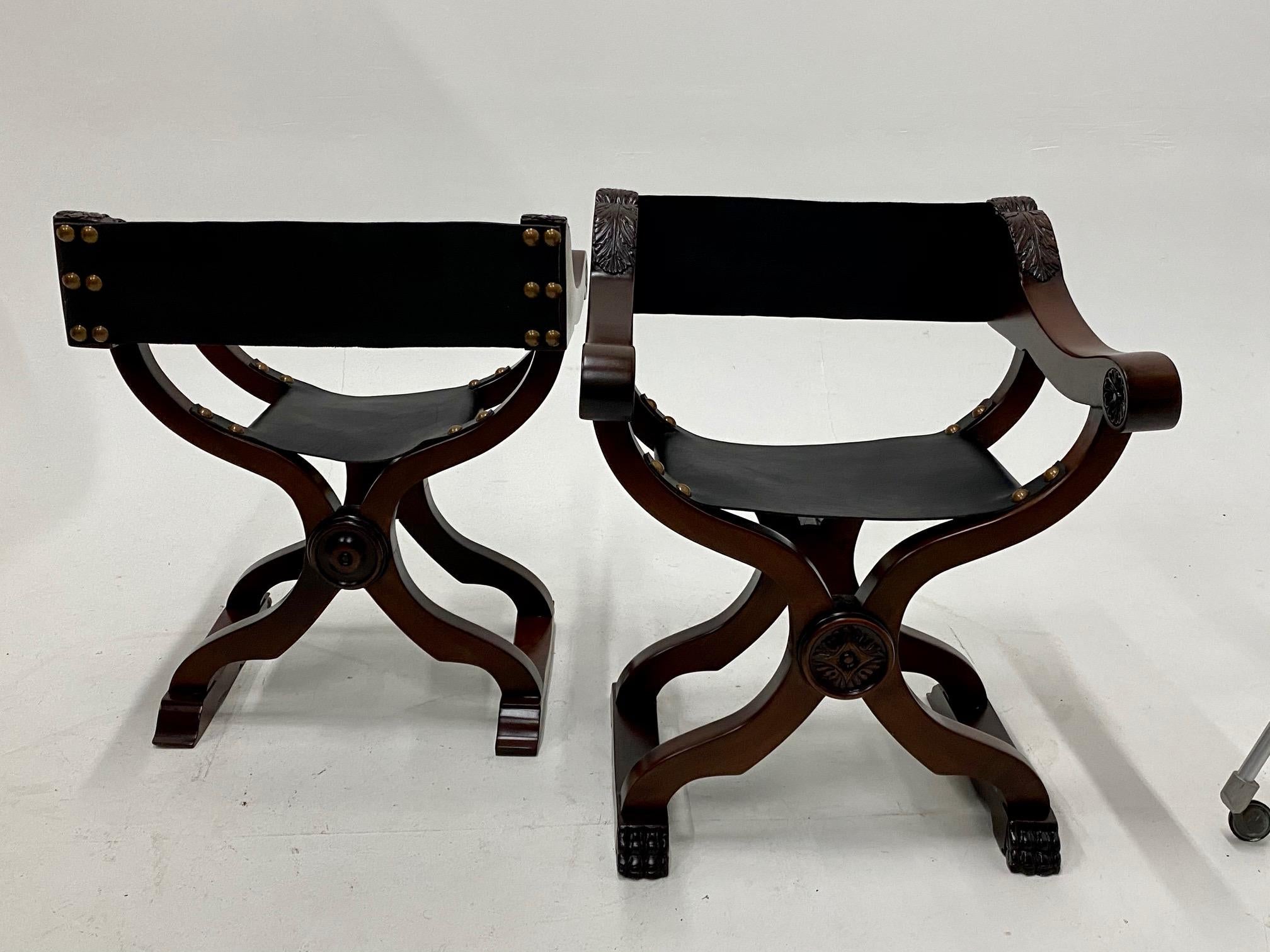 Stunning pair of baroque style Savaranola chairs having rich ashwood frames and supple newly upholstered black leather seats with brass nailheads.