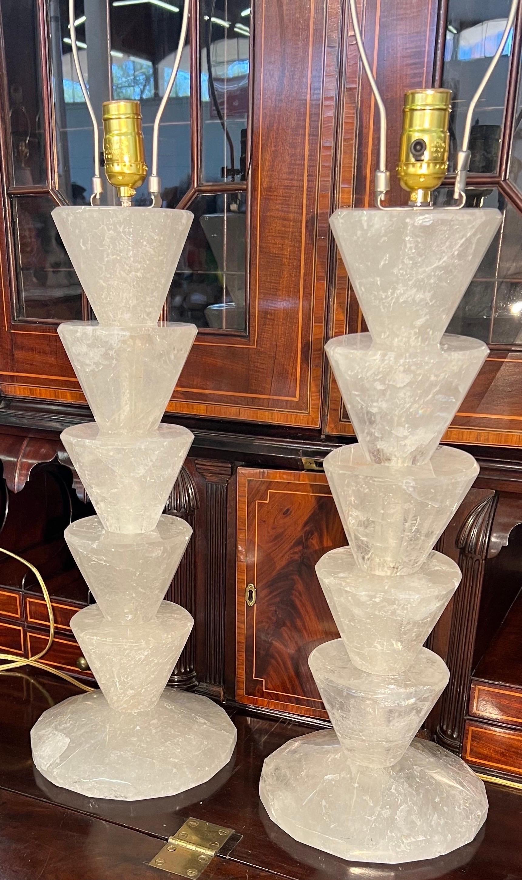 Super chic pair of rock crystal lamps of stacked cut triangular form.