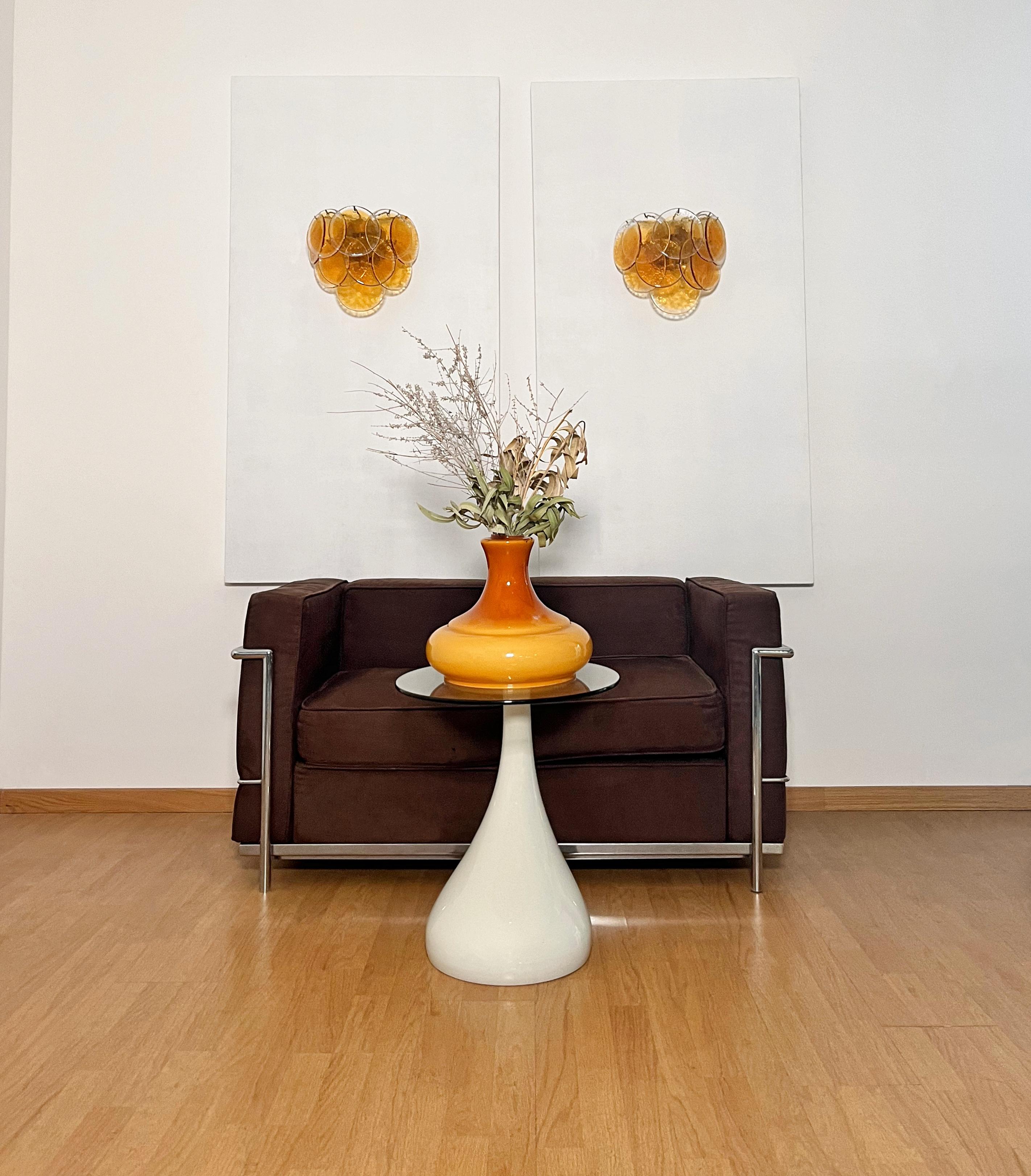 Pair of Vintage Italian Murano wall lights in Vistosi style. Wall lights have 10 transparent glass discs with central amber spot for each. Golden painted metal frame.
Period: late XX century
Dimensions:	11 inches (28 cm) height; 13,40 inches (34 cm)