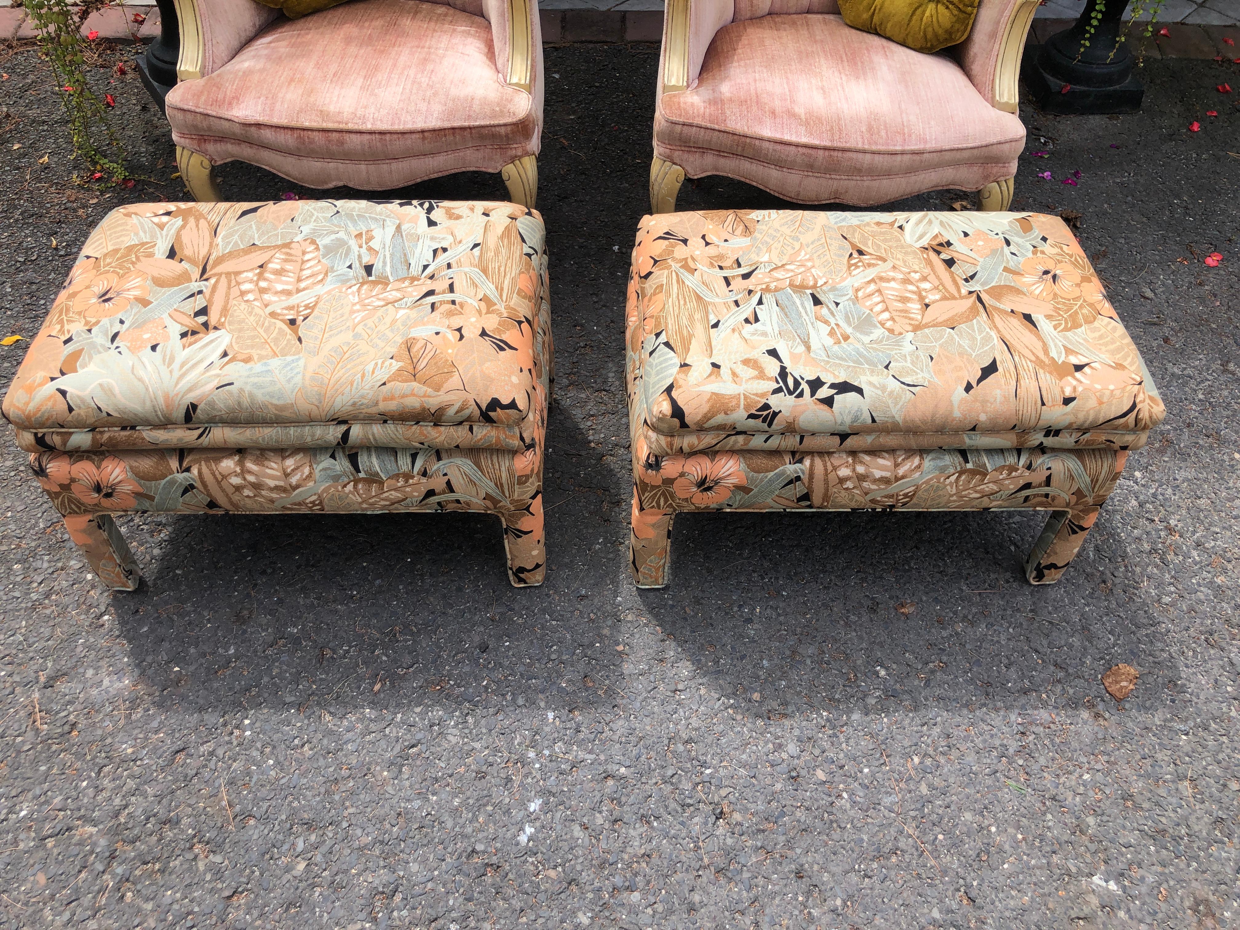 Fantastic pair of upholstered floral linen ottomans. These are in very nice vintage condition with very little wear to their original fabric. The colors are just fabulous with earth tone hues of apricot, brown, and cream. They measure-16