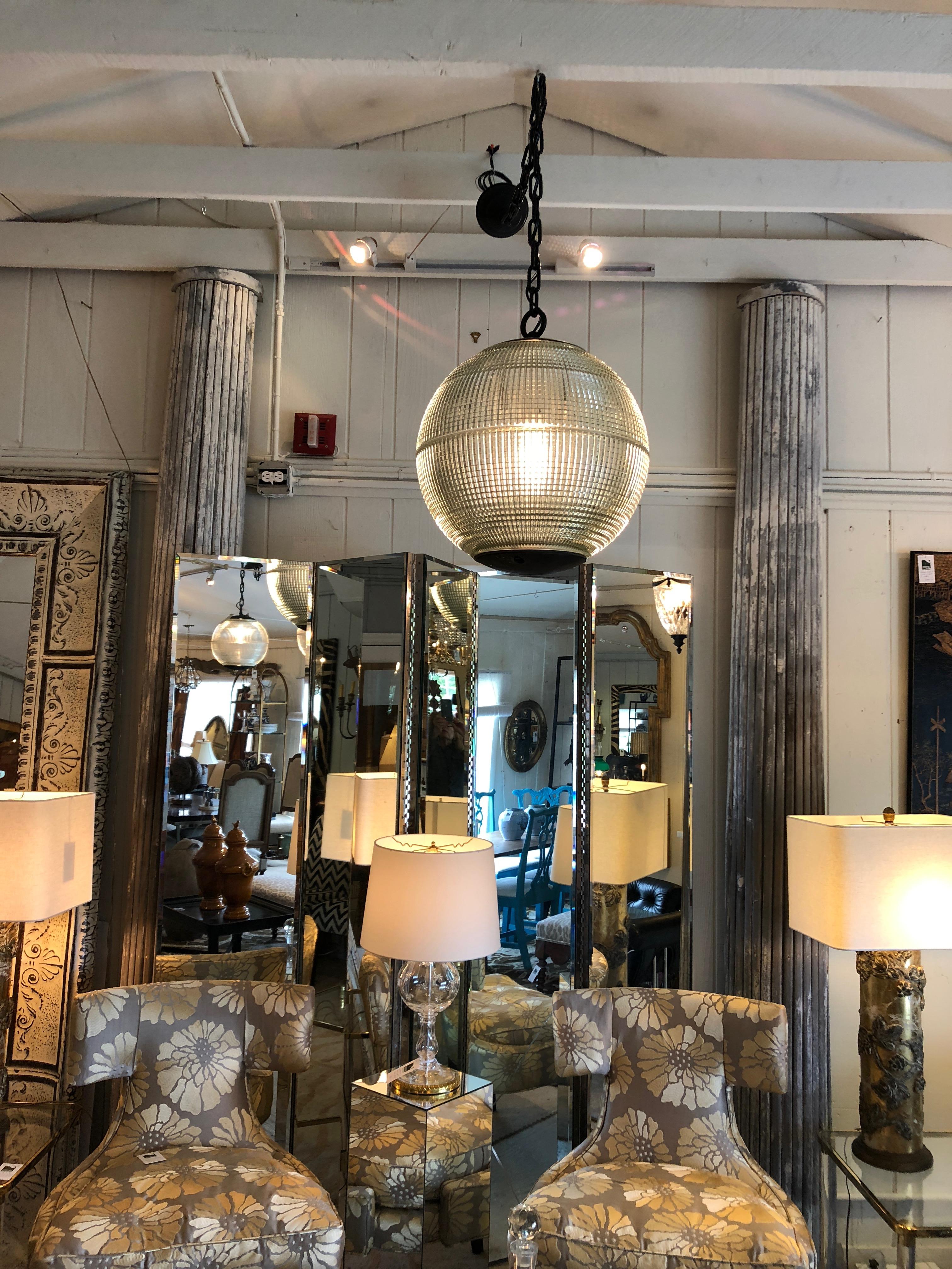 A wonderful very large spherical globe with heavy industrial chain, originally a Paris streetlight and transformed into a hanging pendant. The hallmark of Holophane luminaires, or lighting fixtures, is the borosilicate glass reflector/refractor. The