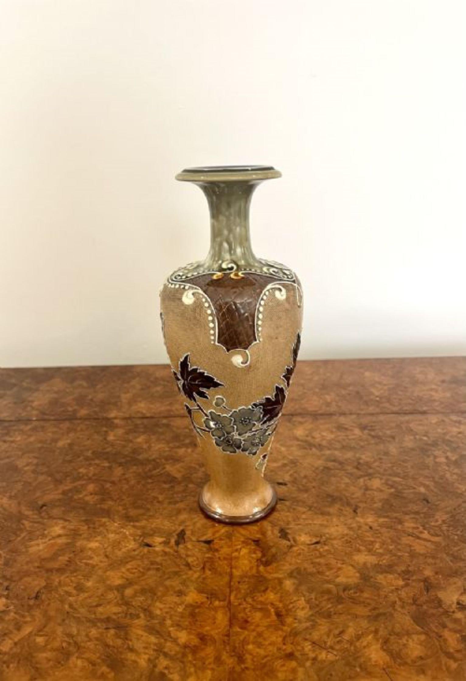 Fantastic quality antique Doulton vase having a fantastic quality Dolton stoneware vase with stunning decoration to the middle with flowers and leaves on a brown background with fabulous detail to the top with scrolls leading to a green fluted neck