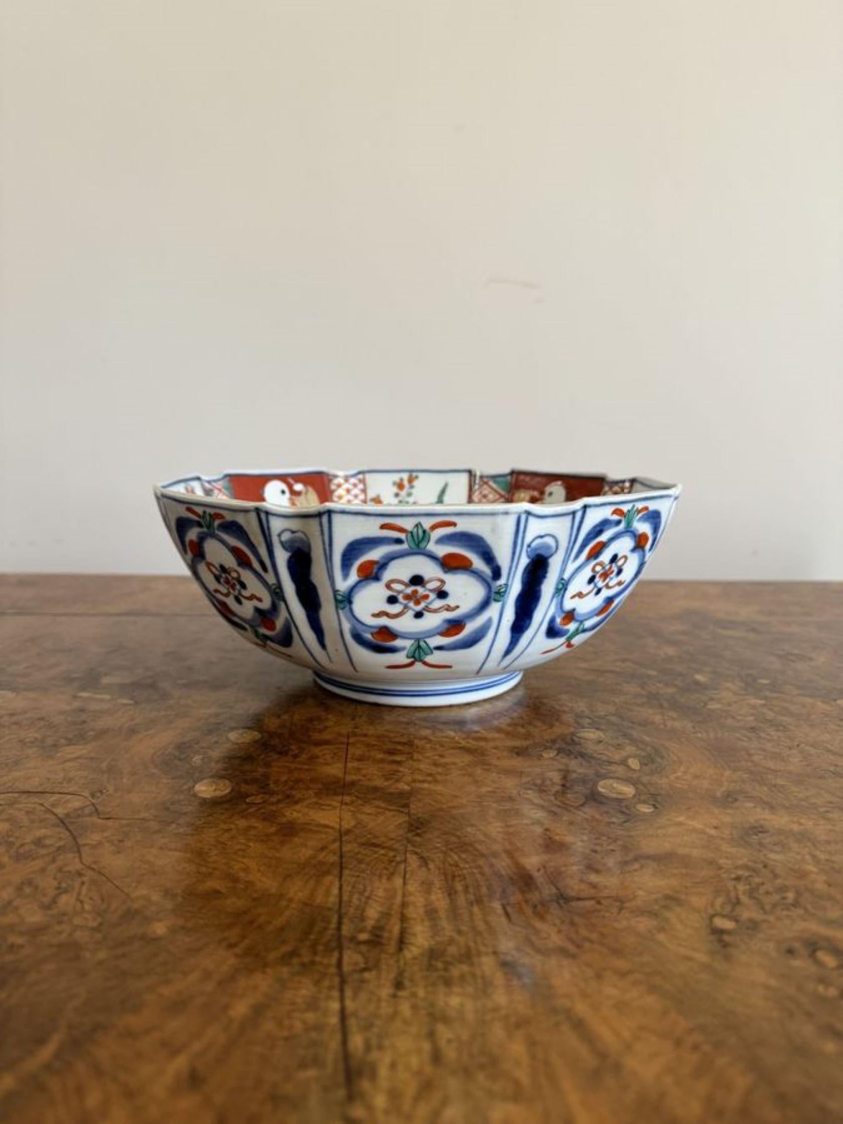Fantastic quality antique Japanese imari bowl having a quality antique Japanese imari bowl with a shaped edge, decorated with flowers to the centre surrounded by panels decorated with figures, flowers and leaves hand painted in stunning red, green,