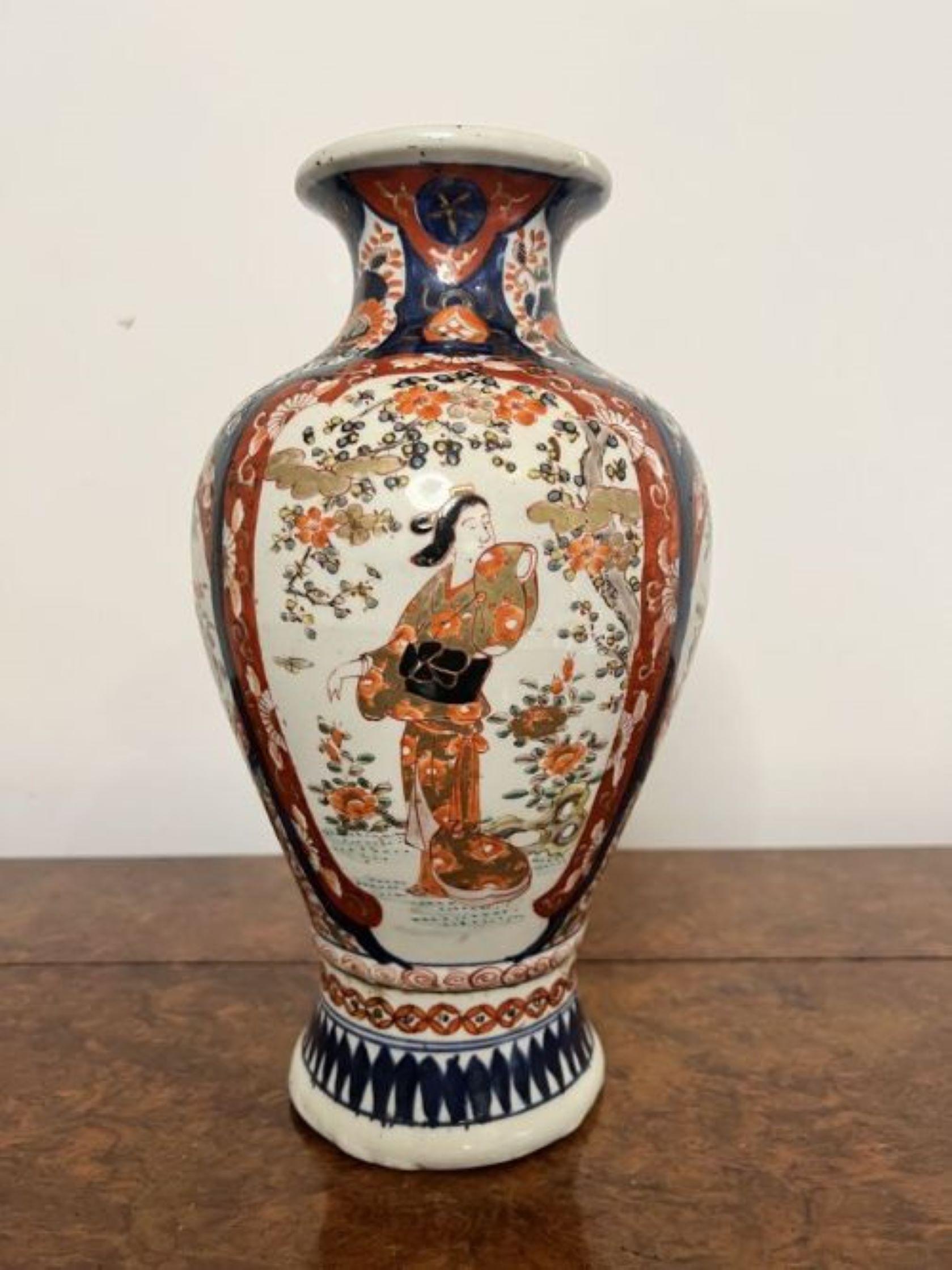 Fantastic quality antique Japanese Imari shaped vase having a quality antique Japanese Imari vase, with a fluted shaped neck and a bulbous body decorated with traditional figures, flowers, trees and patterns in wonderful red, blue, white, green and