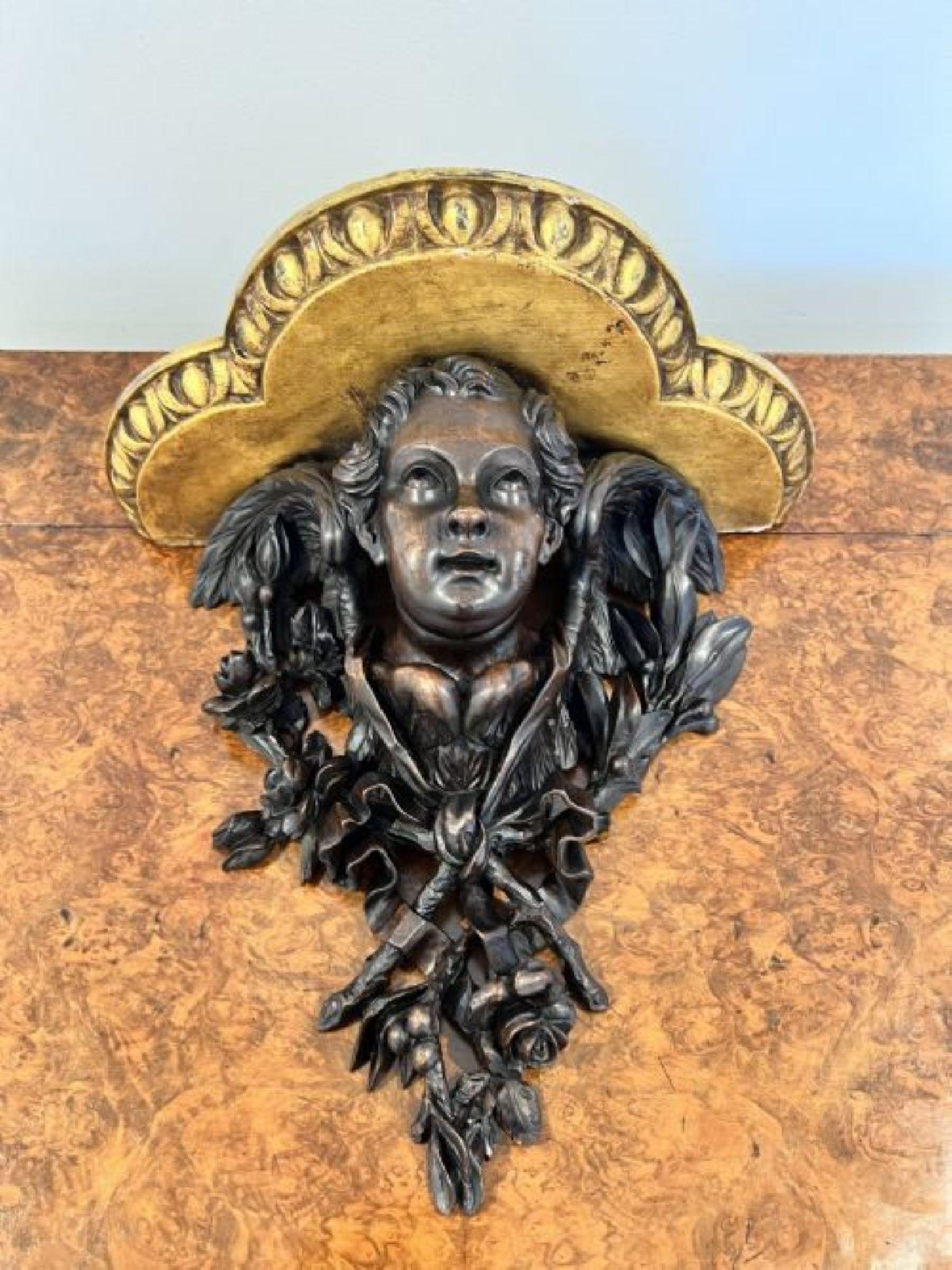 Fantastic quality antique Victorian Black Forest carved call bracket having a fantastic quality black forest carved wall bracket of a man surrounded by flowers and foliage with a gilt top