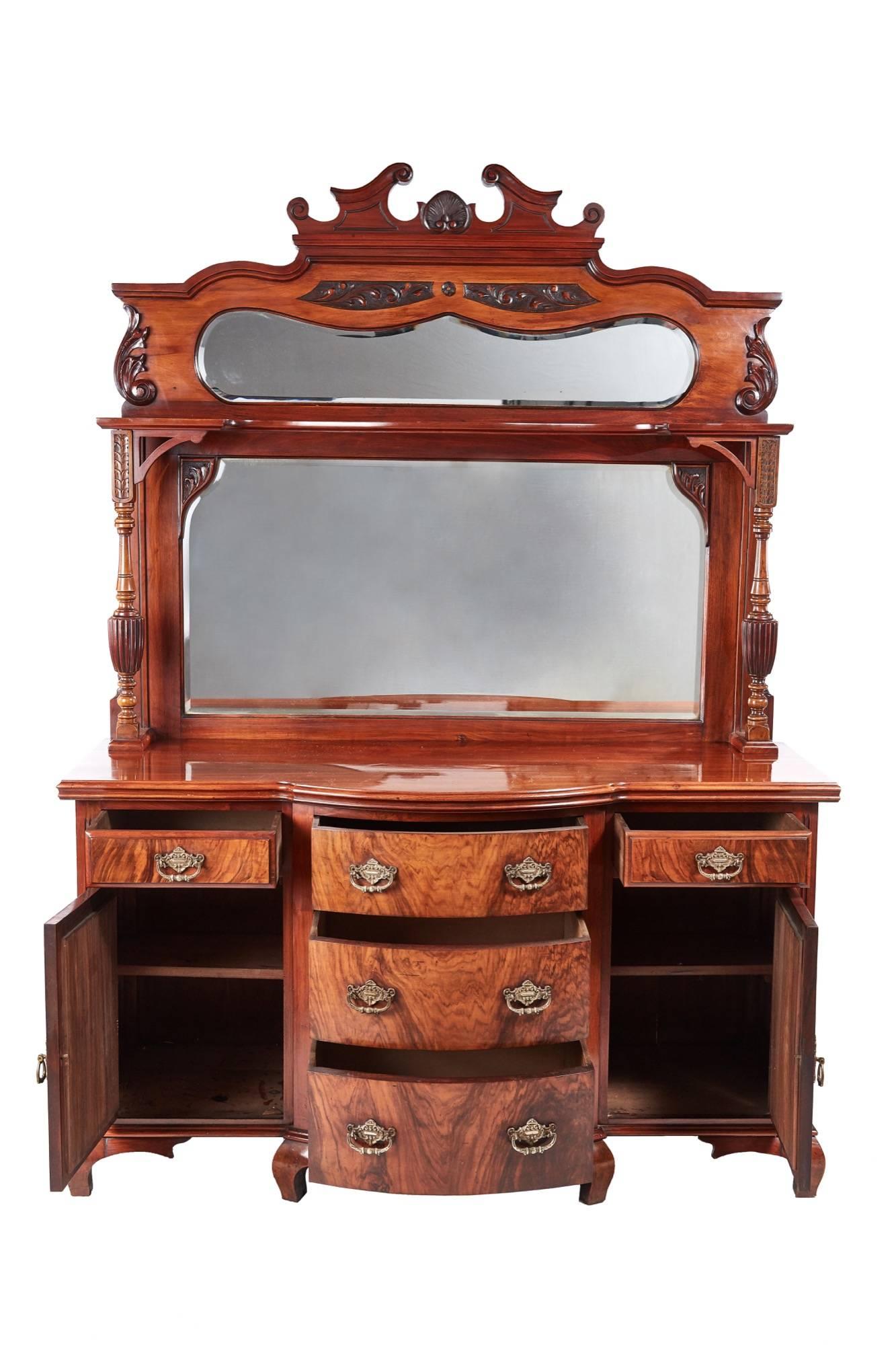 Fantastic quality antique Victorian carved walnut sideboard, with a carved walnut swan-neck pediment, two lovely shaped bevelled edge mirrors, nice carved and reeded columns supporting a shaped shelf, the base with a shaped walnut top, five lovely