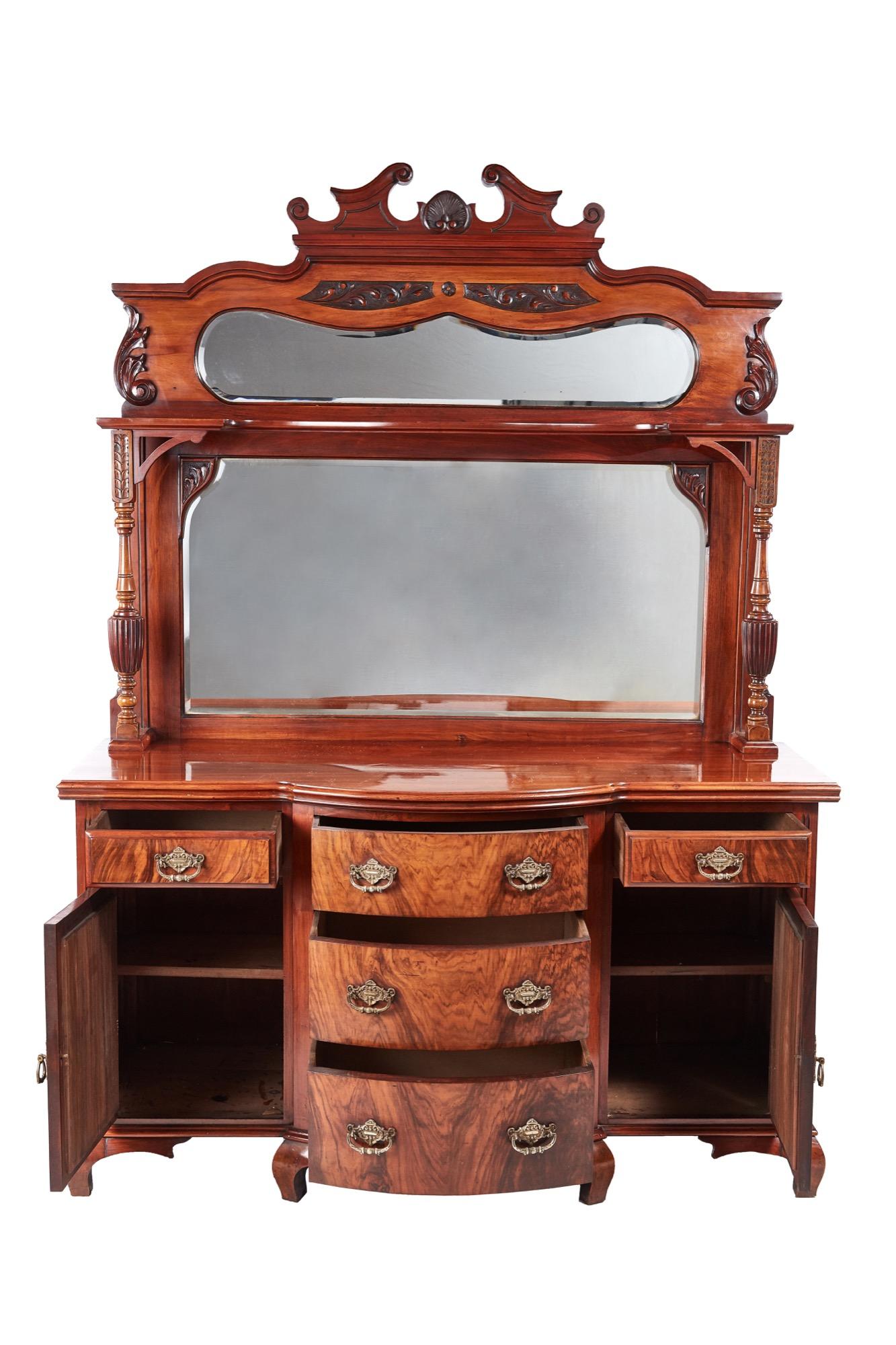 Fantastic quality antique Victorian carved walnut sideboard with a carved walnut swan-neck pediment, two lovely shaped bevelled edge mirrors, beautiful carved and reeded columns supporting a shaped shelf. The base with a shaped walnut top, five