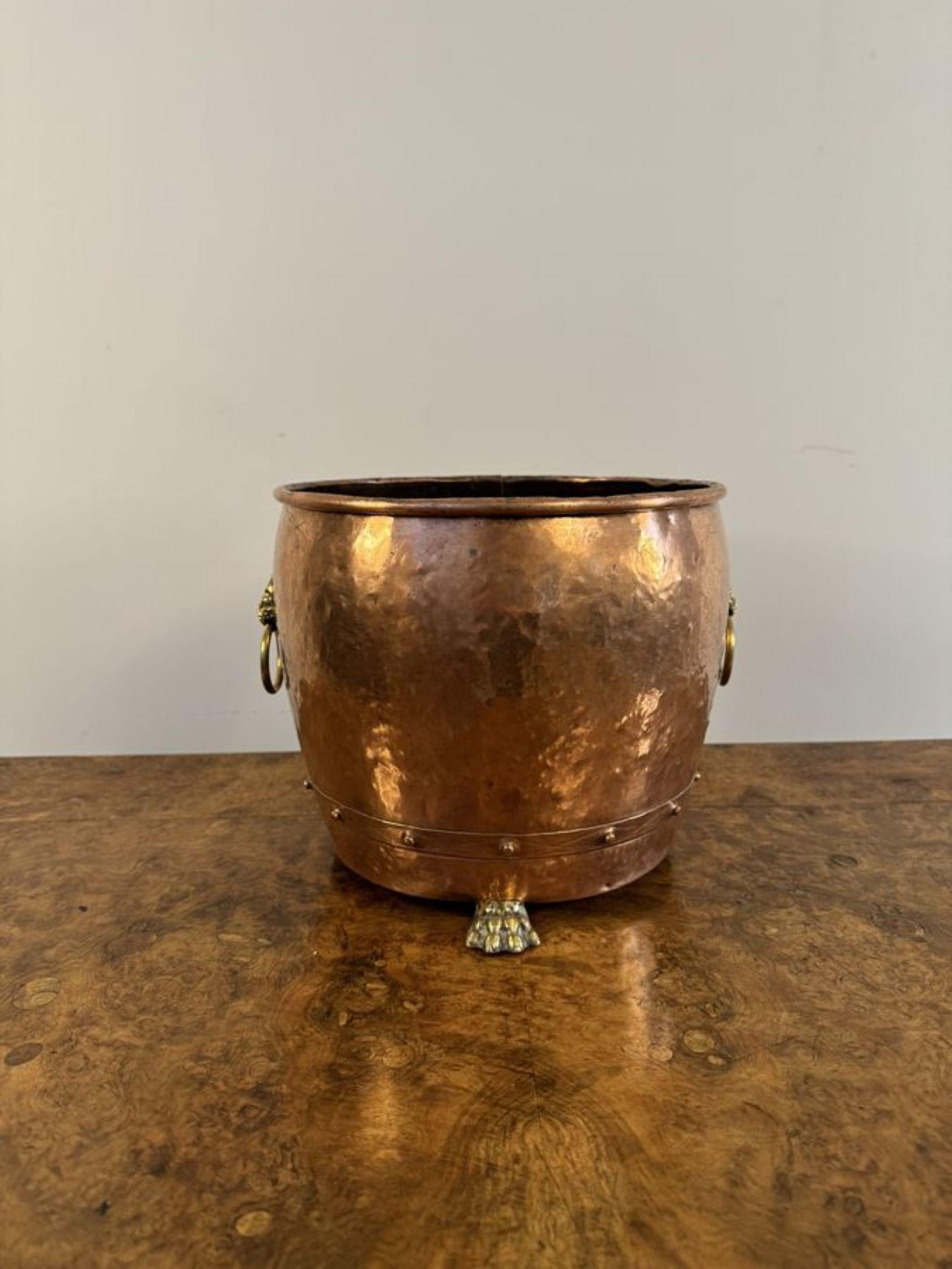 Fantastic quality antique Victorian copper and brass jardiniere having a quality antique Victorian copper jardiniere, circular in shaped, with brass lions head handles to the sides raised on three brass claw feet.

D. 1850