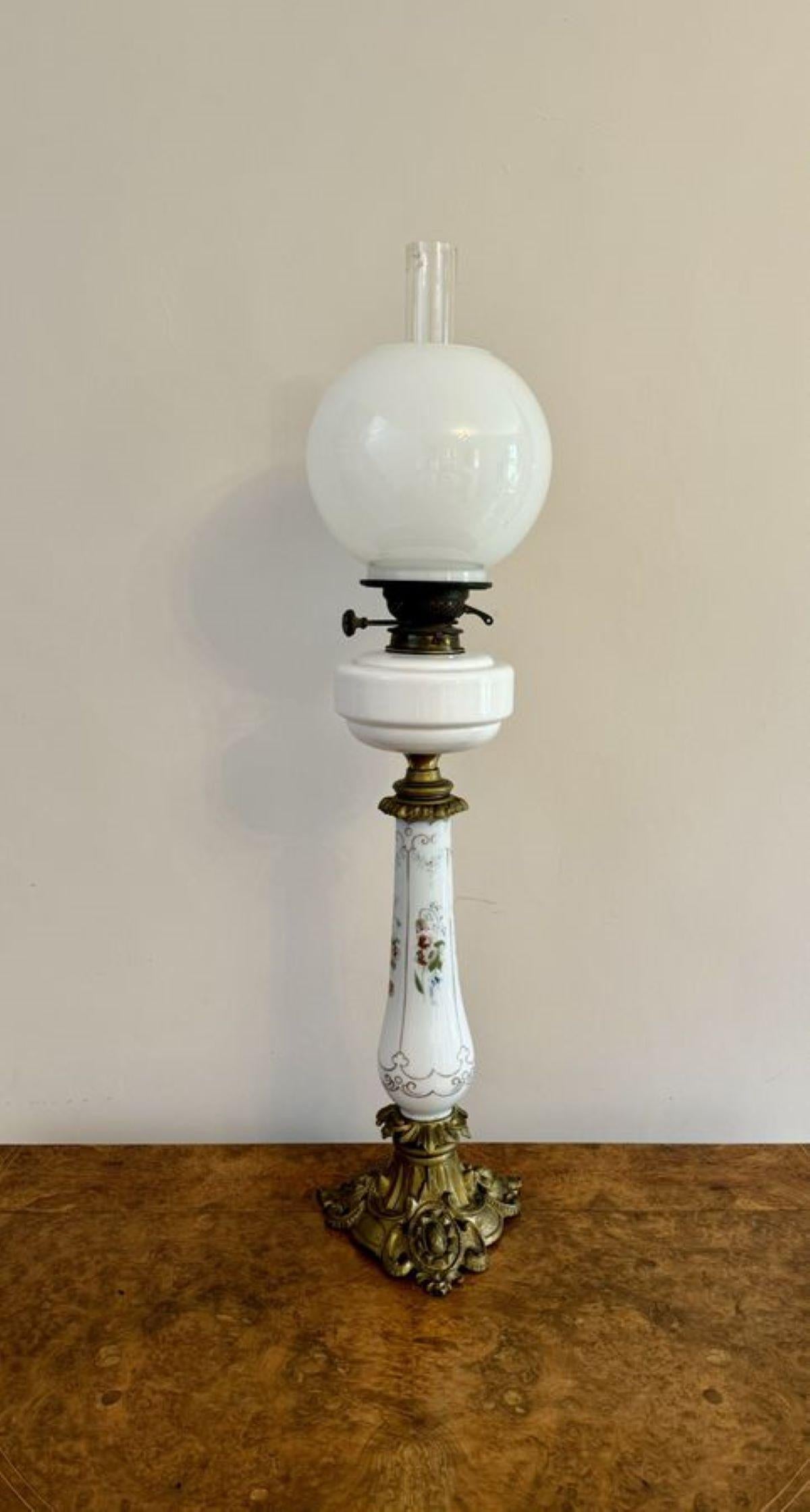 Fantastic quality antique Victorian oil lamp, having a fantastic quality antique Victorian oil lamp, having a double burner, with a white glass globe and glass chimney above a white glass reservoir with a decorated column decorated with flowers hand