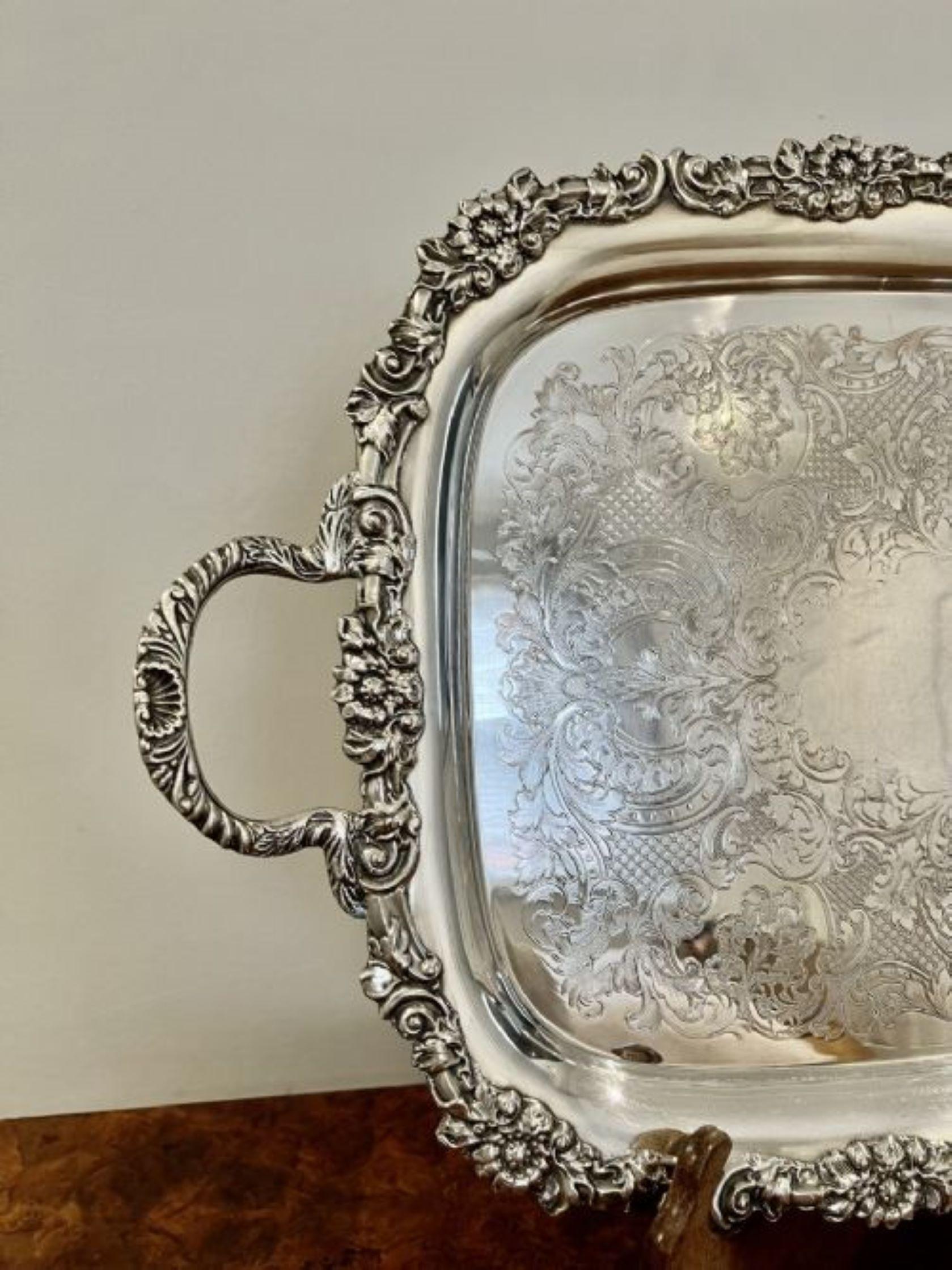 Fantastic quality antique Victorian silver plated ornate serving tray having a quality large serving tray with quality ornate decoration with flowers, leaves and scrolls and two ornate carrying handles to both sides raised on four feet
