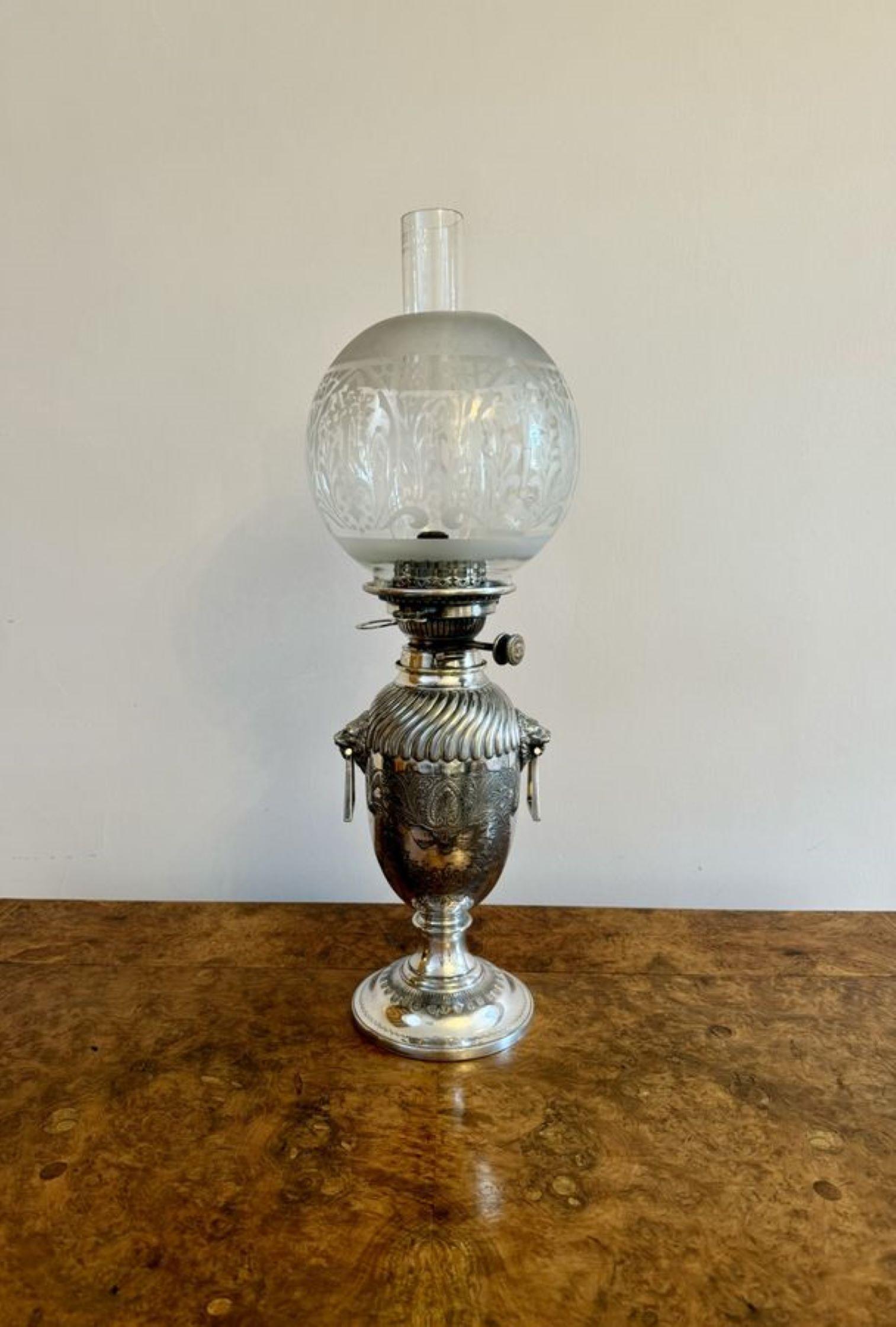 Fantastic quality antique Victorian silver plated urn shaped oil lamp by Hinks and Sons, with a glass chimney and etched glass globe, having a silver plated urn shaped base with spirally fluted top above a pair of angular lion mask handles to the