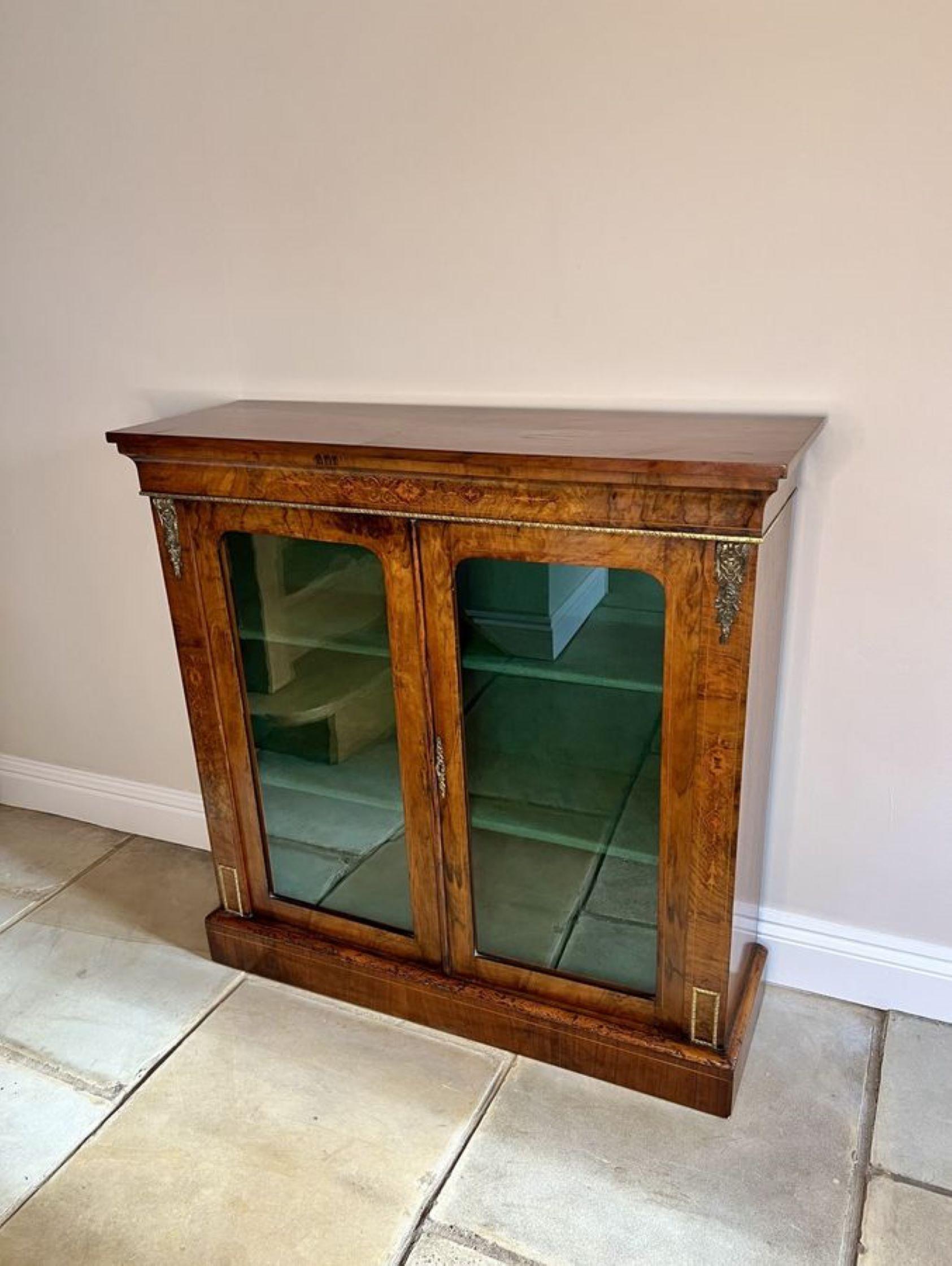 Fantastic quality antique Victorian walnut inlaid pier cabinet, having a fantastic quality antique Victorian walnut inlaid pier cabinet with stunning gilt metal mounts, having a rectangular walnut top above a pair of glazed doors opening to reveal