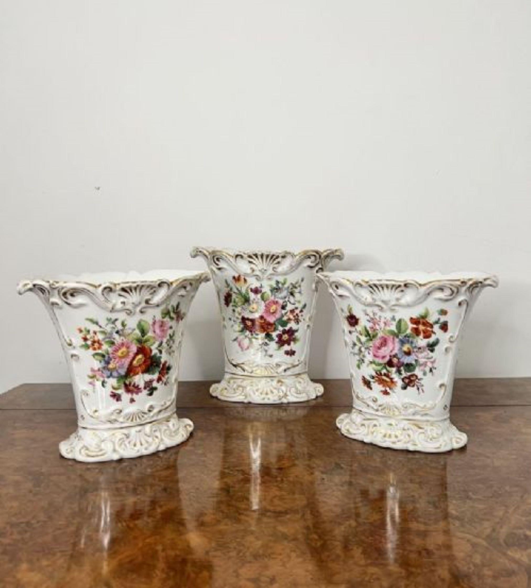 Fantastic quality garniture of three 19th century French vases having a fantastic garniture of three French vases, with fluted shaped bodies with floral decoration in fabulous blue, pink, green and orange colours surrounded by gold gilding standing