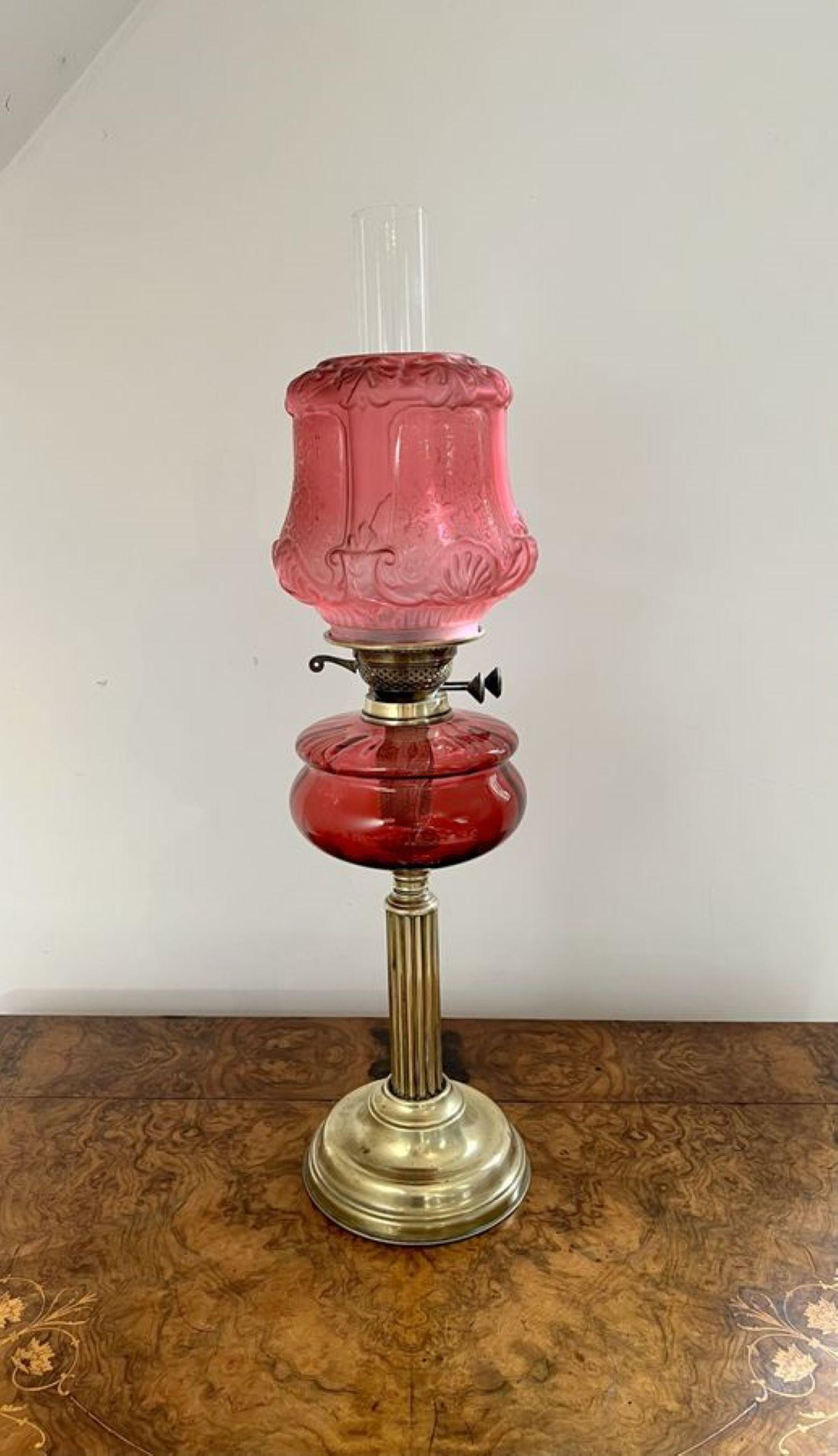 Fantastic quality large antique Victorian cranberry glass and brass oil lamp having a quality brass oil lamp with a cranberry glass shaped shade, with a cranberry glass reservoir supported on a brass Corinthian column, raised on a circular brass