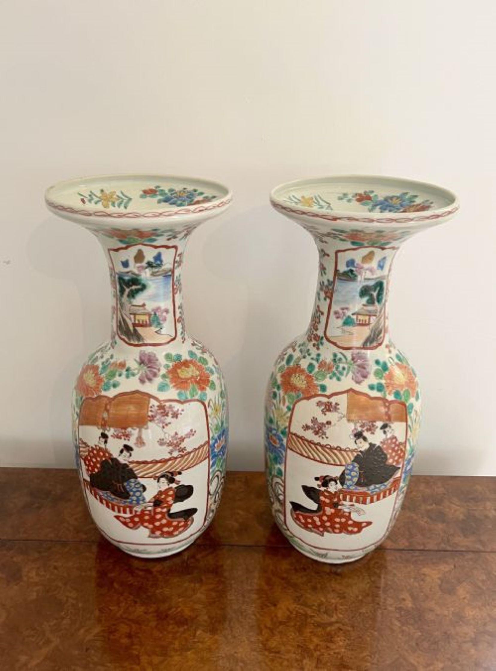 Fantastic quality pair of large antique Japanese imari vases having a fantastic quality pair of antique Japanese imari vases decorated with traditional Japanese figures, scenery and flowers hand painted in wonderful green, orange, red, black, blue