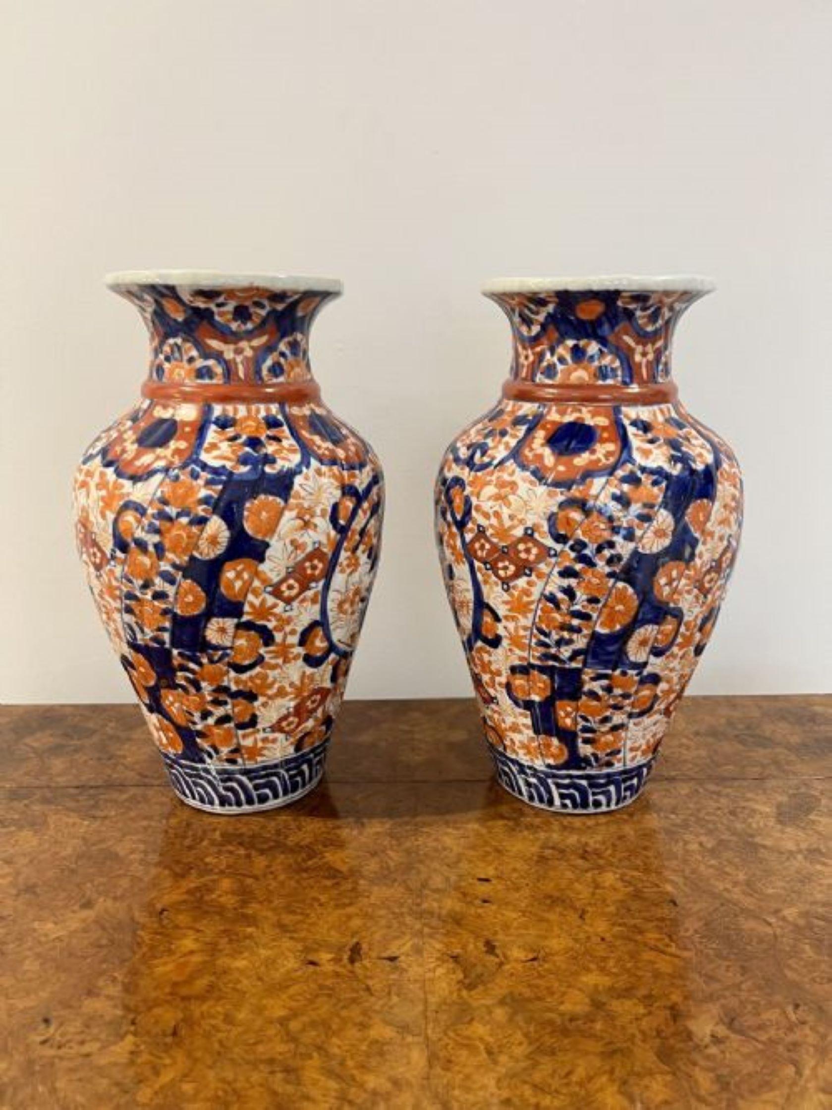 Fantastic quality pair of large antique Japanese Imari vases in wonderful hand painted red, blue and white colours decorated with a basket of flowers to the front and back surrounded by flowers and leaves. 