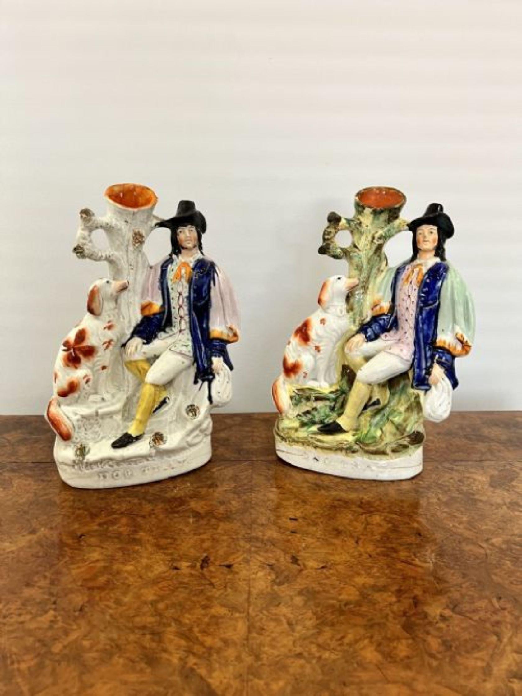 Fantastic rare large pair of antique Victorian Staffordshire figures having a fantastic rare pair of staffordshire figures with a man in lovely period clothing, a dog and a tree surrounded by foliage in vibrant green, blue, white, yellow and red