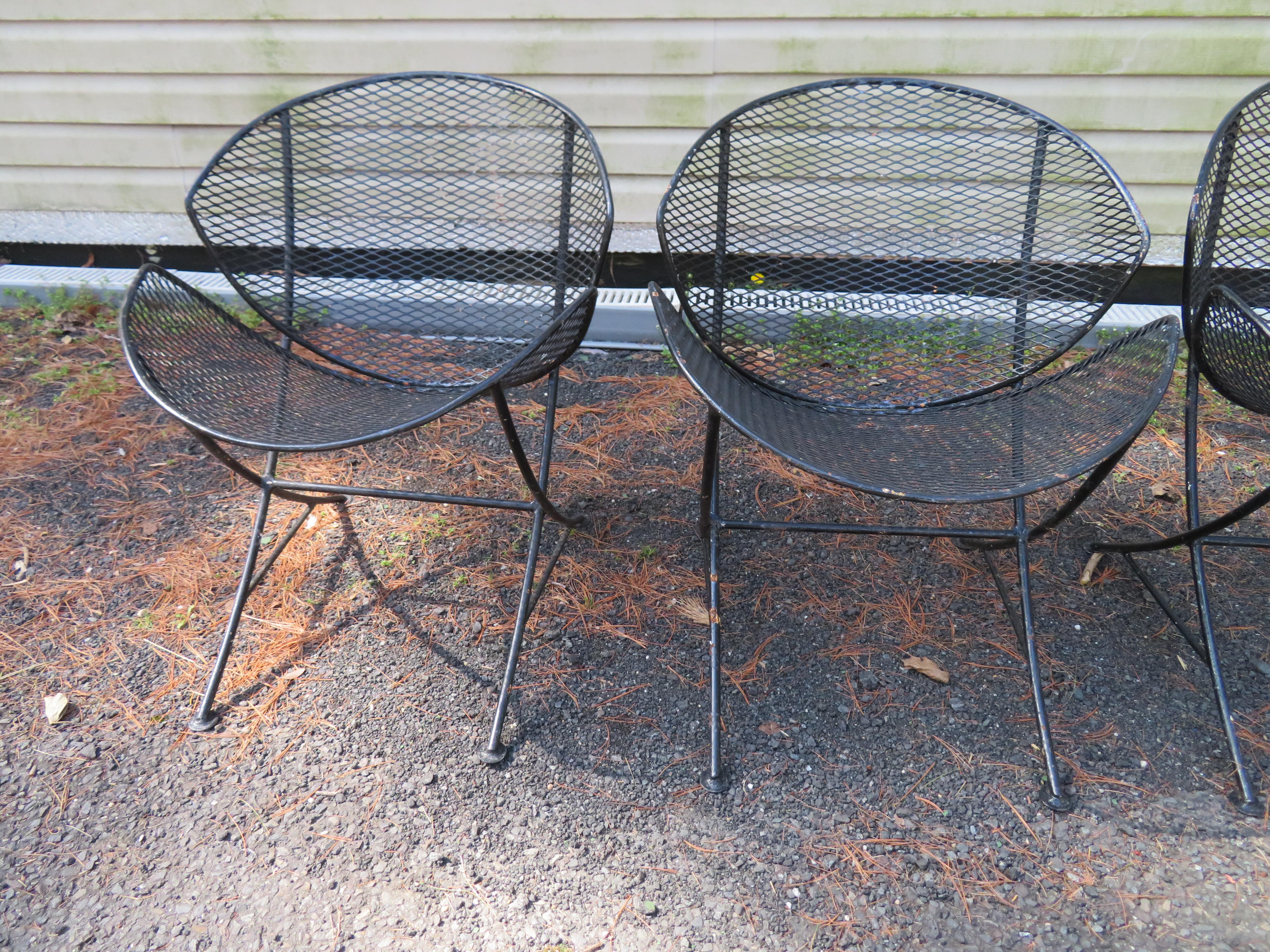Fantastic set of 4 wrought iron and metal mesh lounge designed by Maurizio Tempestini and manufactured by Salterini. Wrought iron frames with metal mesh seats and backs. All chairs are in very good original condition, showing only cosmetic wear to