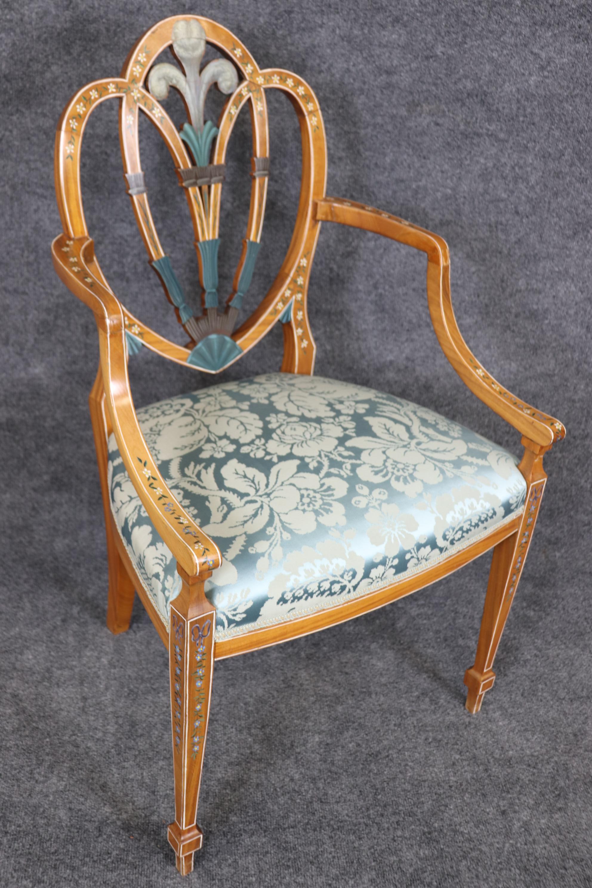This is a fantastic set of English-made paint decorated solid satinwood shiled back dining chairs with what appears to be a soft blue silk damask on the seats. They are in very good condition for their age and they have absolutely gorgeous