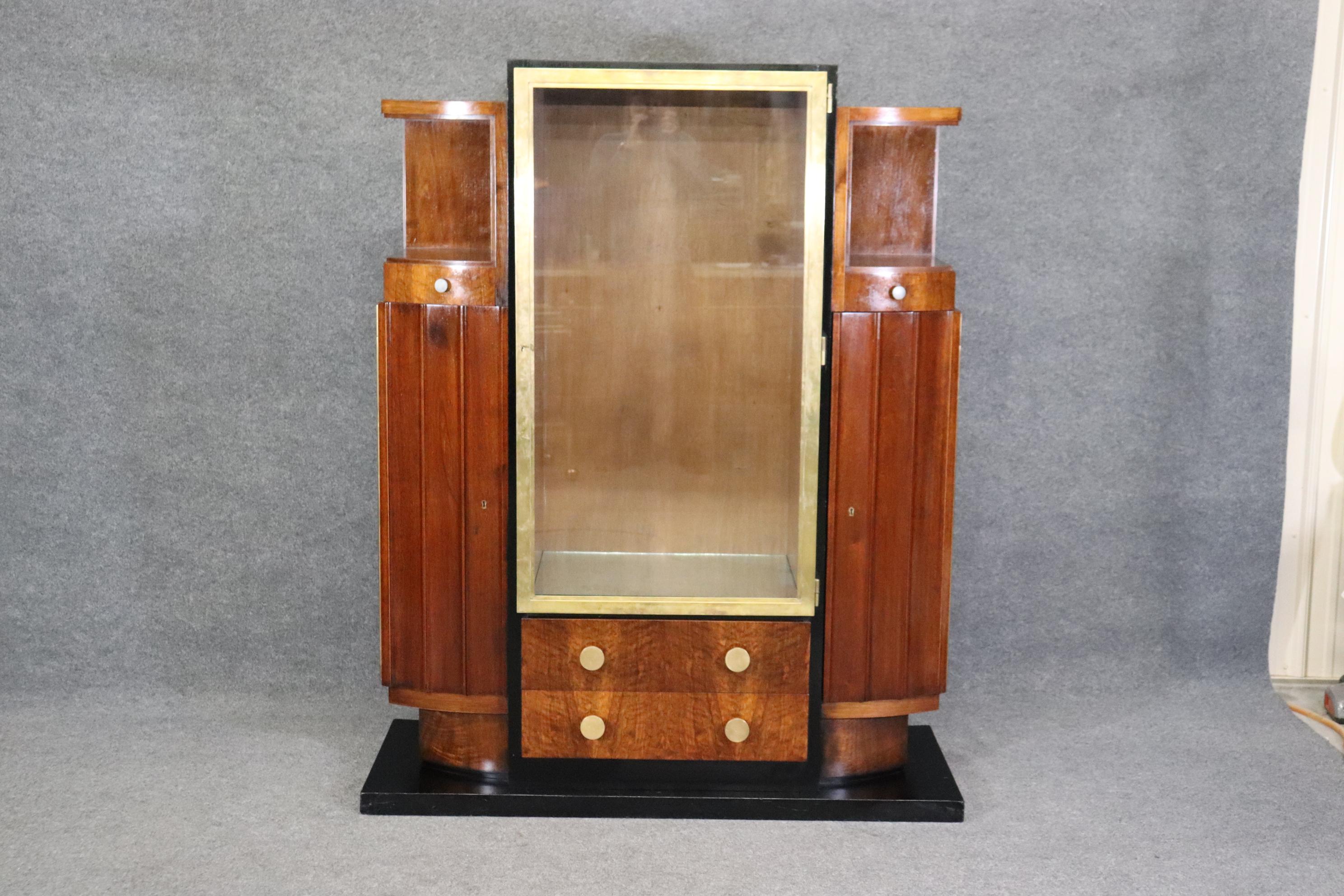 This is an absolutely breathtaking French Art deco signed china cabinet or vitrine. The signature is probably upside down and we are trying to identify it, but the design reminds me of Jules Leleu and features incredible wood quality with highly