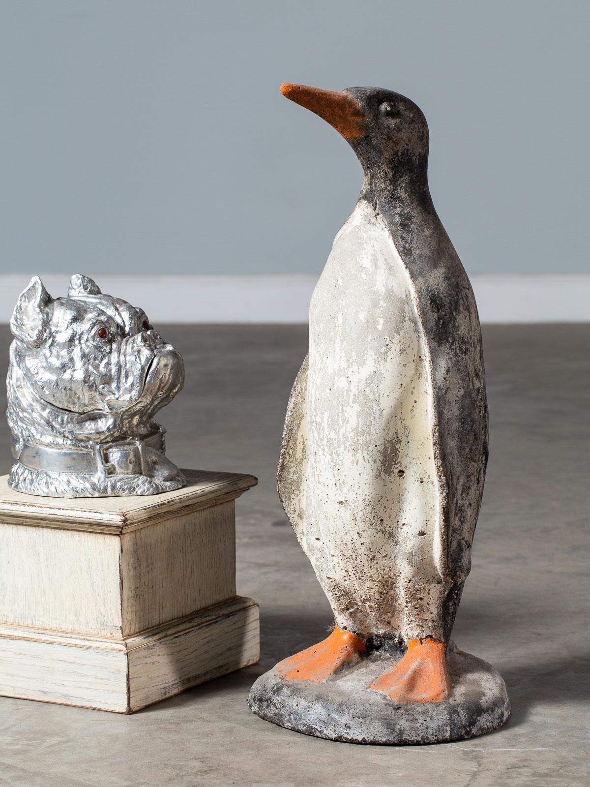 A fantastic vintage French concrete garden penguin circa 1930 standing on a plinth base. Beautifully rendered with life like details this vintage penguin has charm and personality. Sculpted and painted to match a living penguin this fine example is
