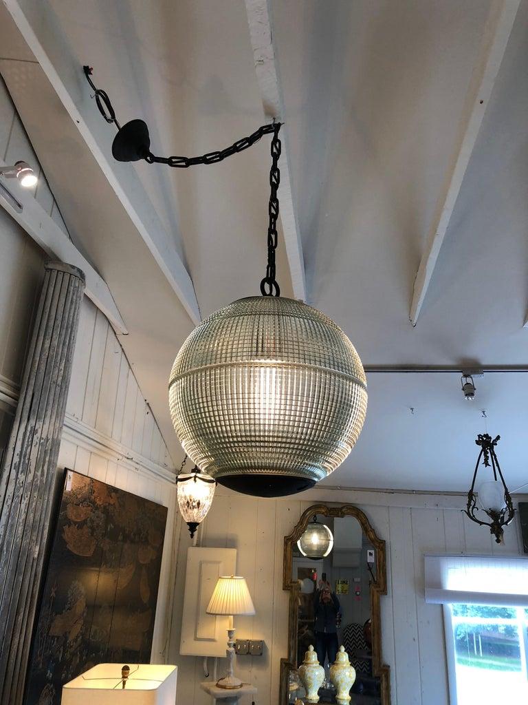 Glamorous and impressive very large spherical globe with heavy industrial chain, originally a Paris streetlight and transformed into a hanging pendant. The hallmark of Holophane luminaires, or lighting fixtures, is the borosilicate glass
