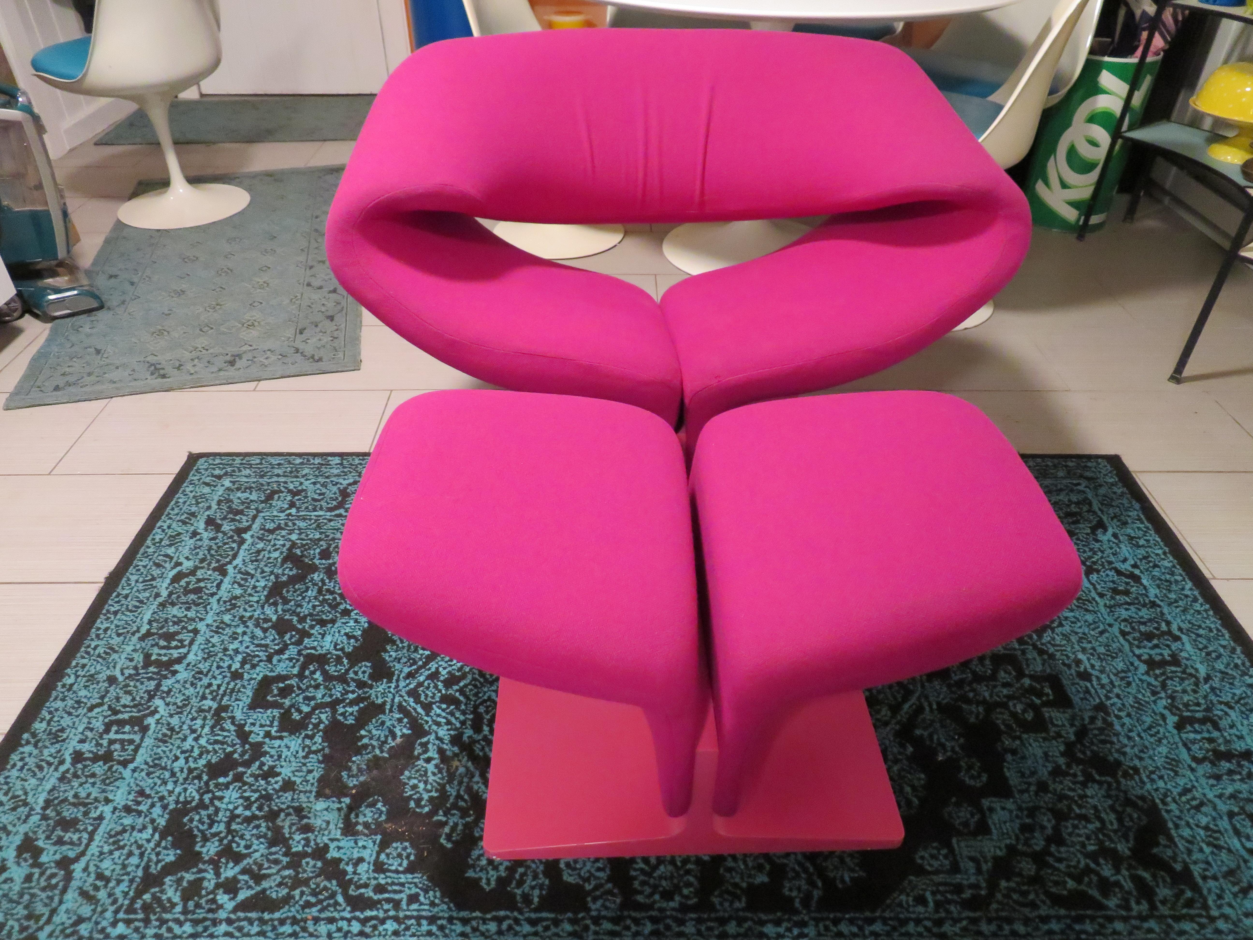 This iconic and innovative Ribbon chair and matching ottoman designed by Pierre Paulin for Artifort is a stunning organic form of contoured tubular steel that is ergonomically designed for comfort. This vintage set retains their original Barbie pink