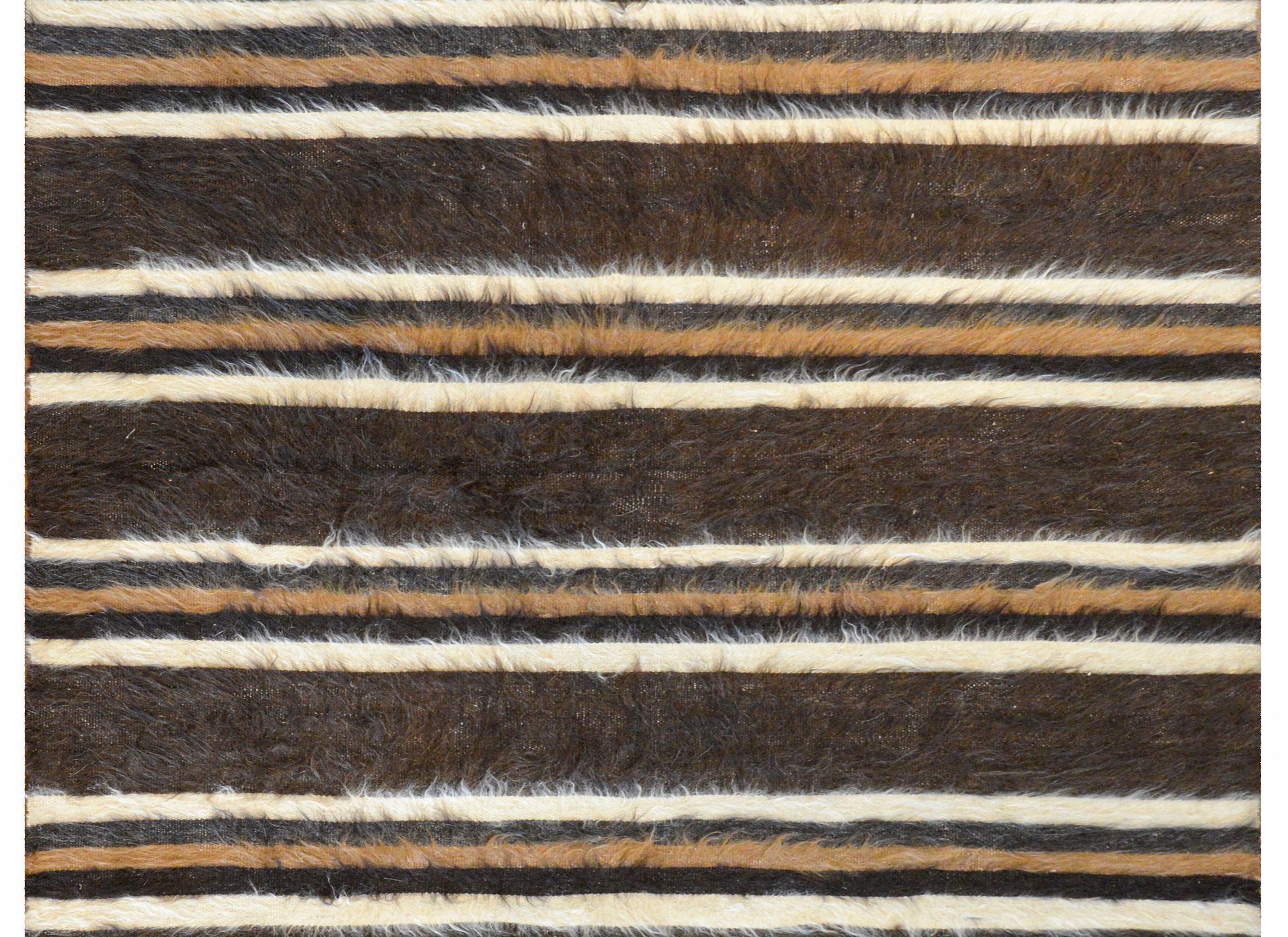 A fantastic vintage Turkish Siirt rug woven with alternating brown, black, white, and camel-colored stripes.
